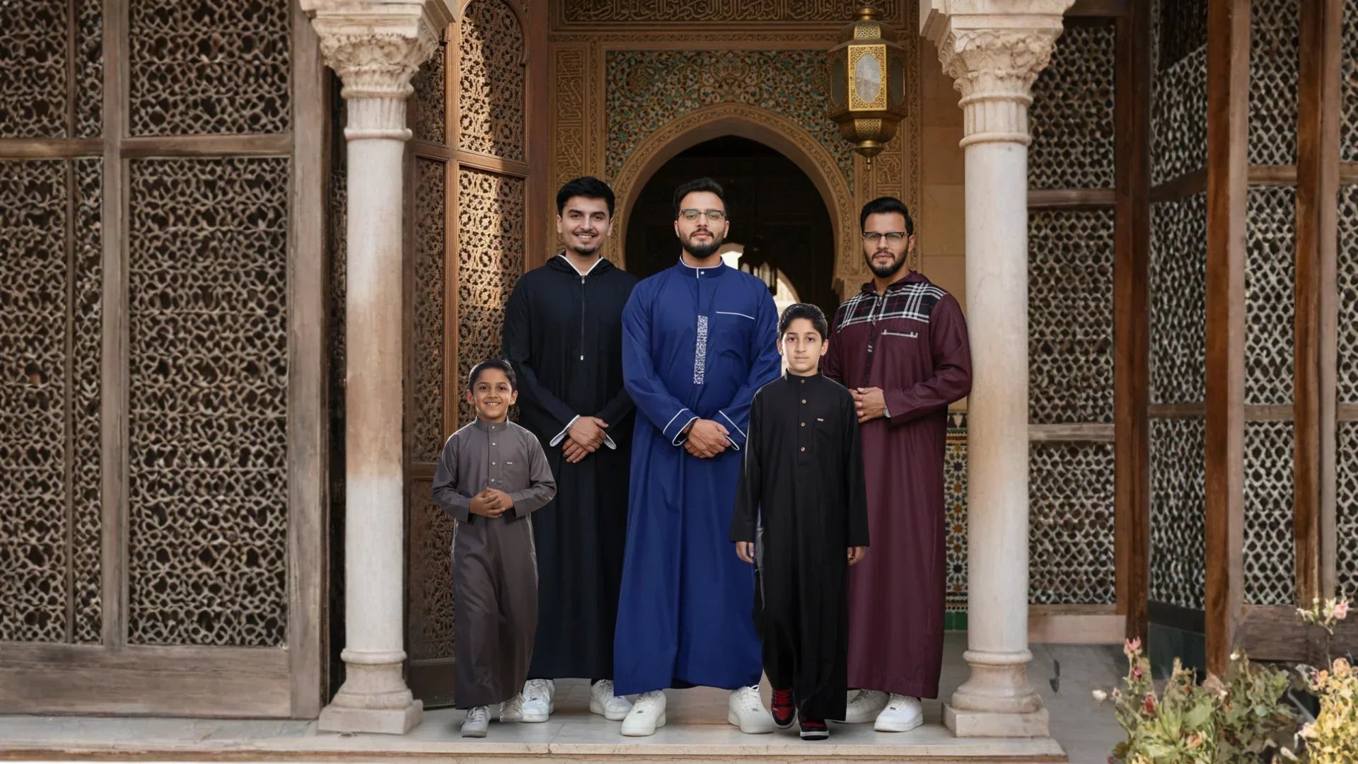 Group of Muslim men and kids wearing premium Sunnah-inspired thobe styles for Jumu'ah Friday prayer. Featuring blue, black, and maroon jubbas by TheTopiWala.