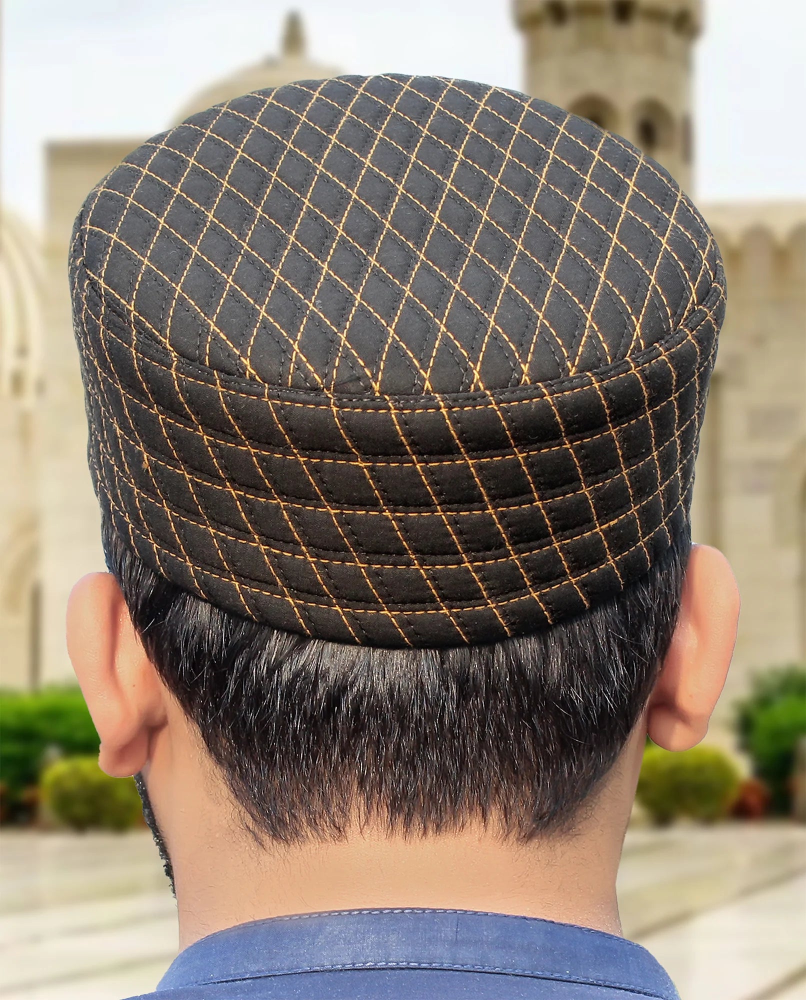 Black Noor Kufi with gold contrast stitching in a diamond quilt pattern, built for durability.