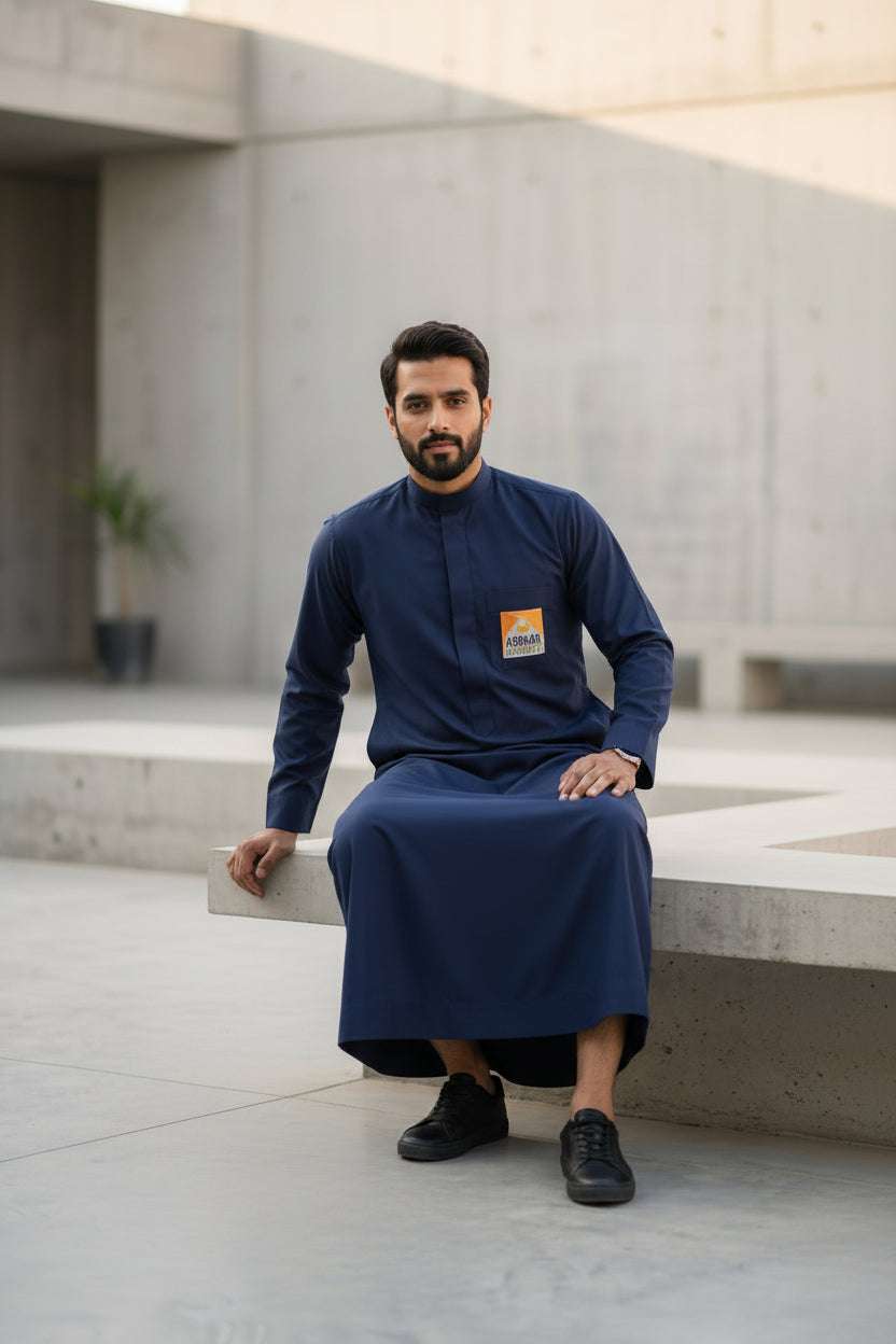 Official Abraar Academy navy blue men's uniform thobe with custom logo patch.