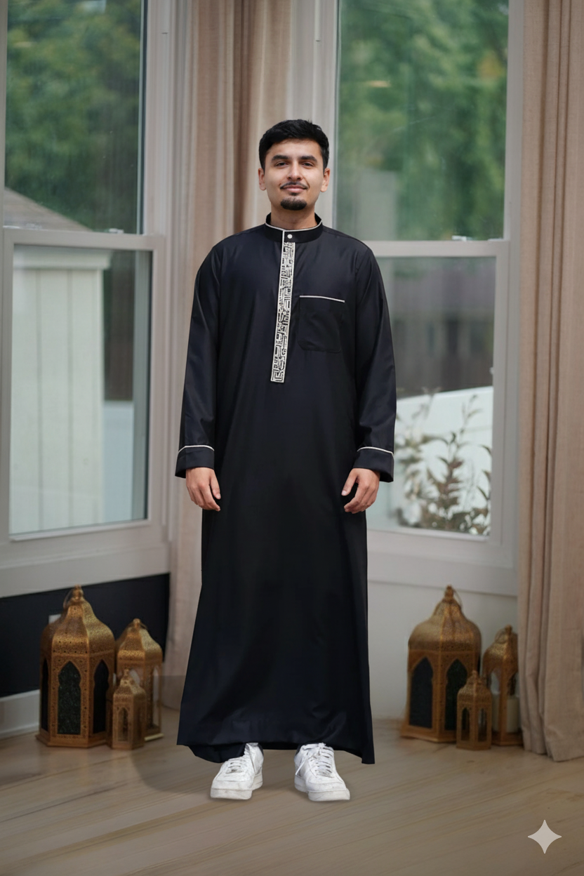 Flat lay image of the folded Men's Black & Gold Embroidered Thobe showing the premium color contrast