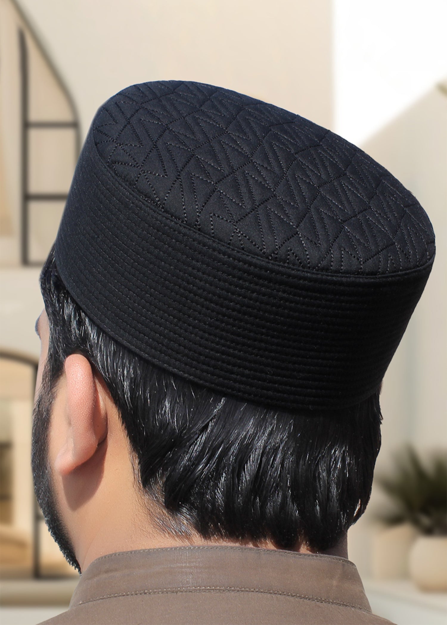 Front view of the Badar Kufi showing the intricate chevron quilted pattern and structured shape