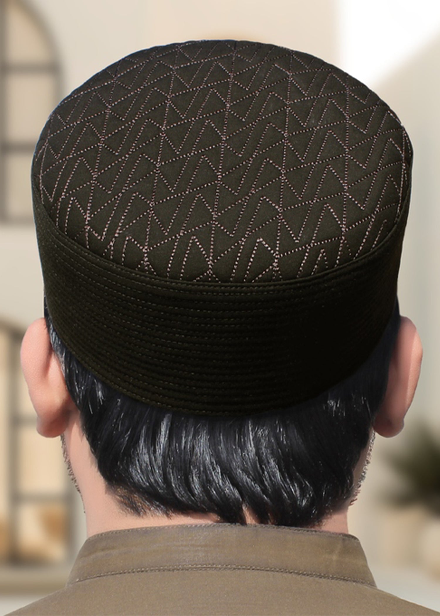 Lifestyle shot of a man wearing the Badar Kufi while raising hands for dua