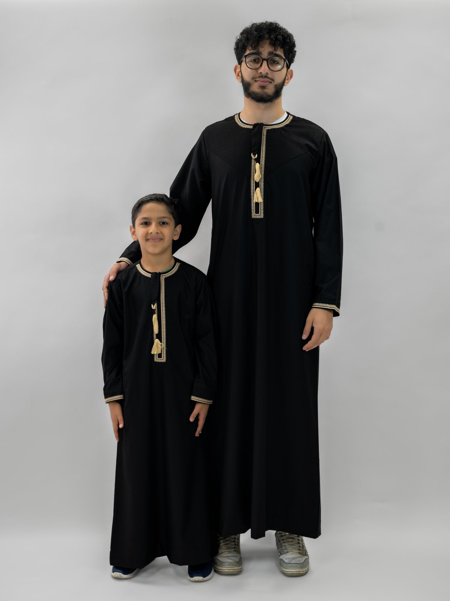 Black emirati gold trim tarboush thobe for men and boys, side profile view