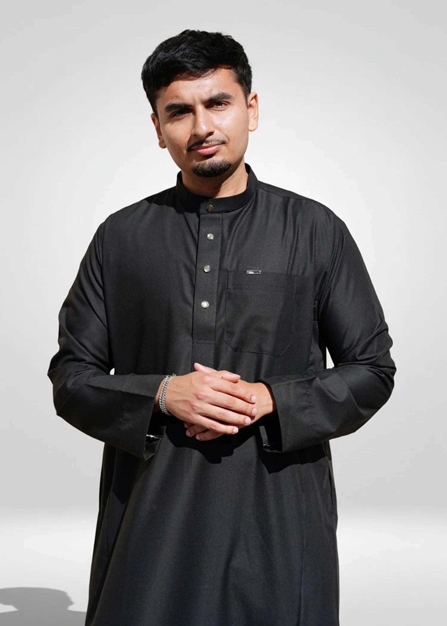 Black thobe with mandarin collar for men, close-up of the sleeve cuff