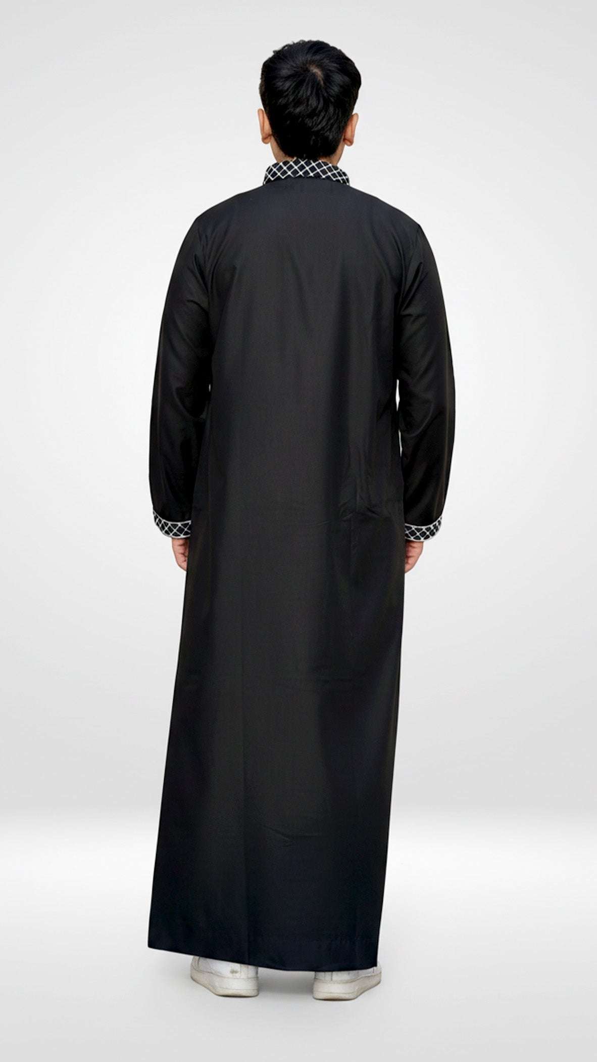 Black Palestine embroidered thobe with mandarin collar for men, worn by a model outdoors