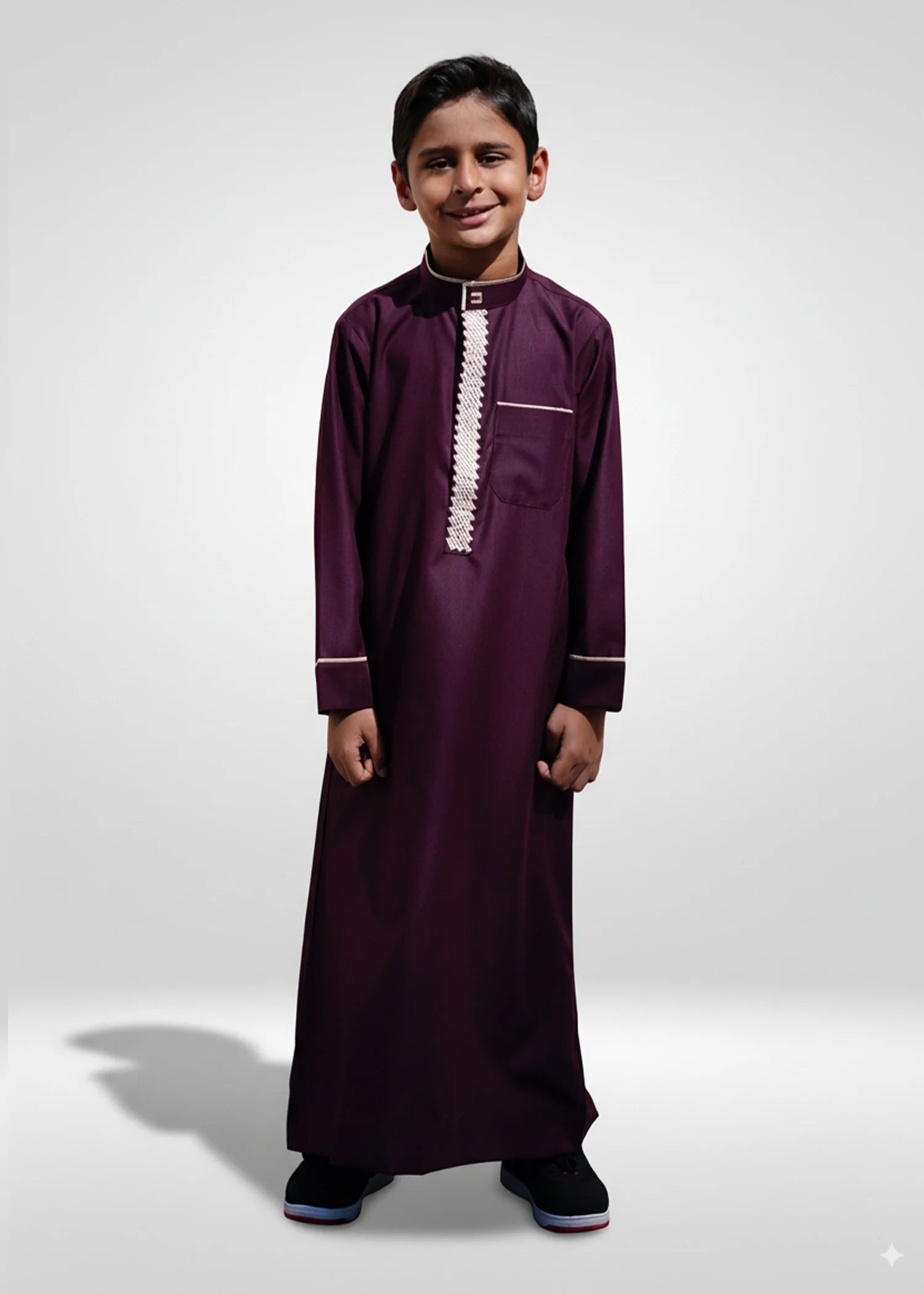 Stylish boys Eid outfit inspiration featuring maroon thobe paired with a traditional kufi