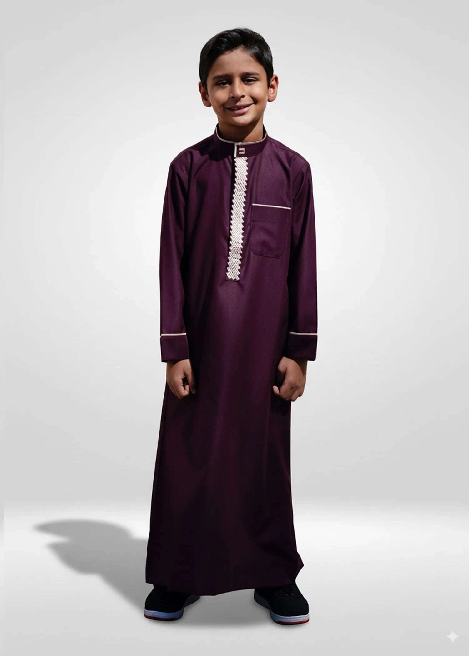 Stylish boys Eid outfit inspiration featuring maroon thobe paired with a traditional kufi