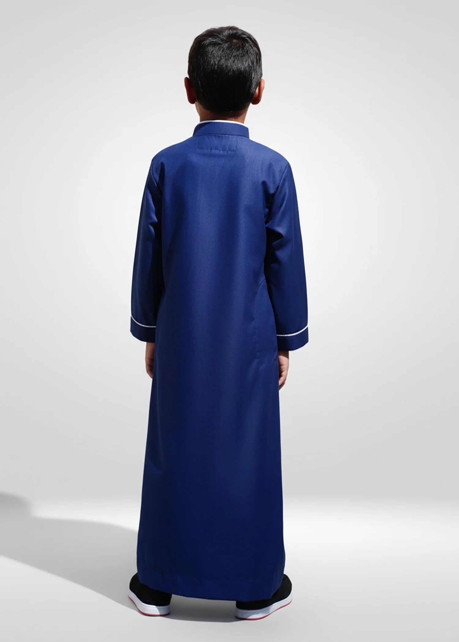 Back view of the Navy Blue & White Kids Embroidery Thobe highlighting the deep color and clean drape