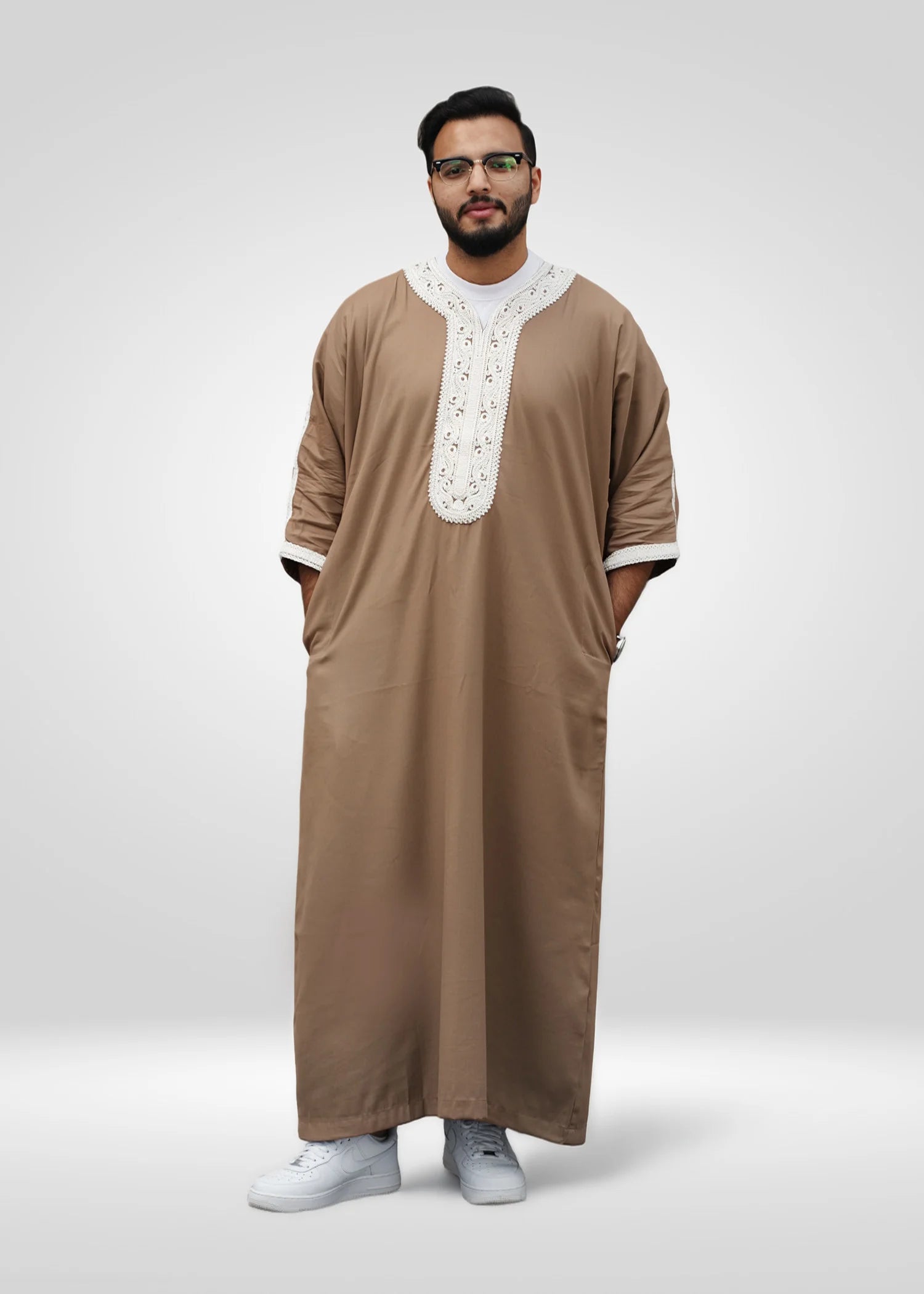 Side view of the beige gandora showing the loose sleeves and comfortable drape