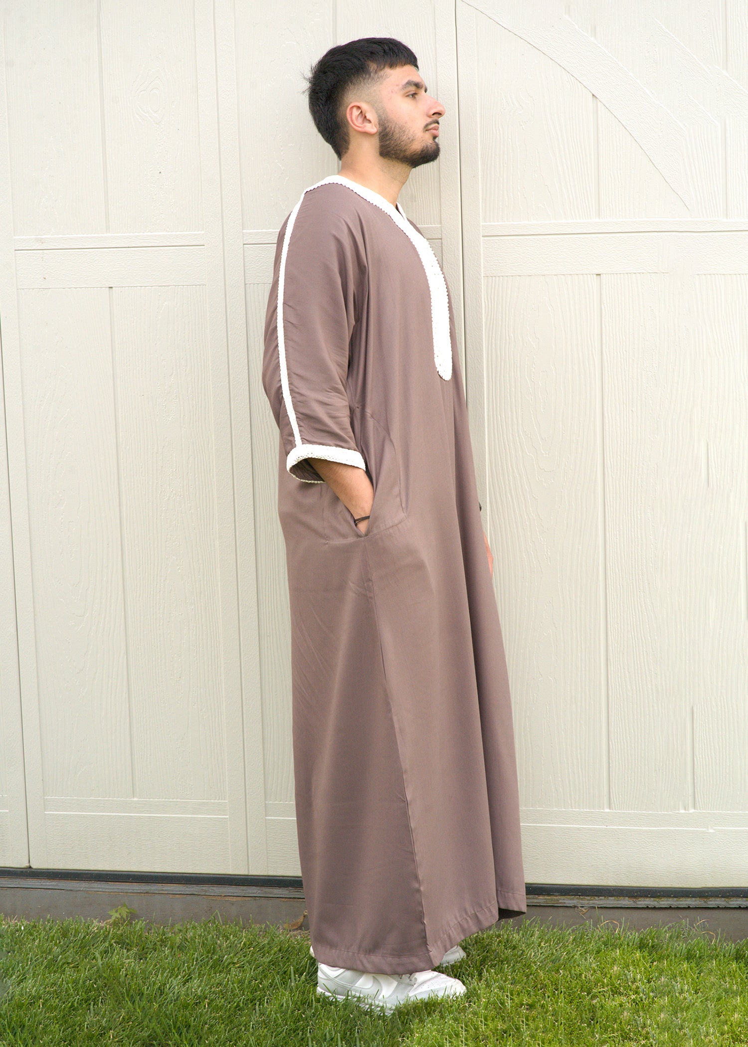 Full body back view showing the drape of the lightweight fabric and the traditional silhouette of the men's Jubba.