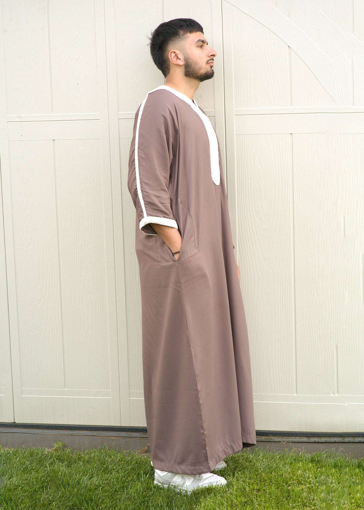 Side view of the taupe gandora showing the loose sleeves and comfortable drape