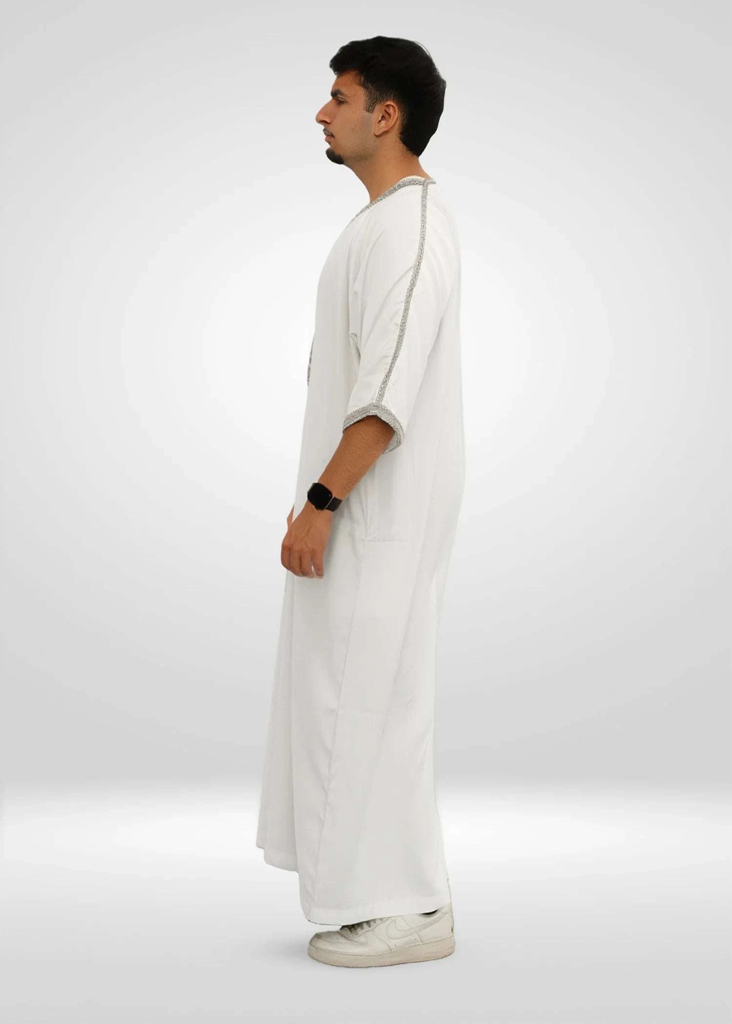 Side view of the white gandora showing the loose sleeves and comfortable drape