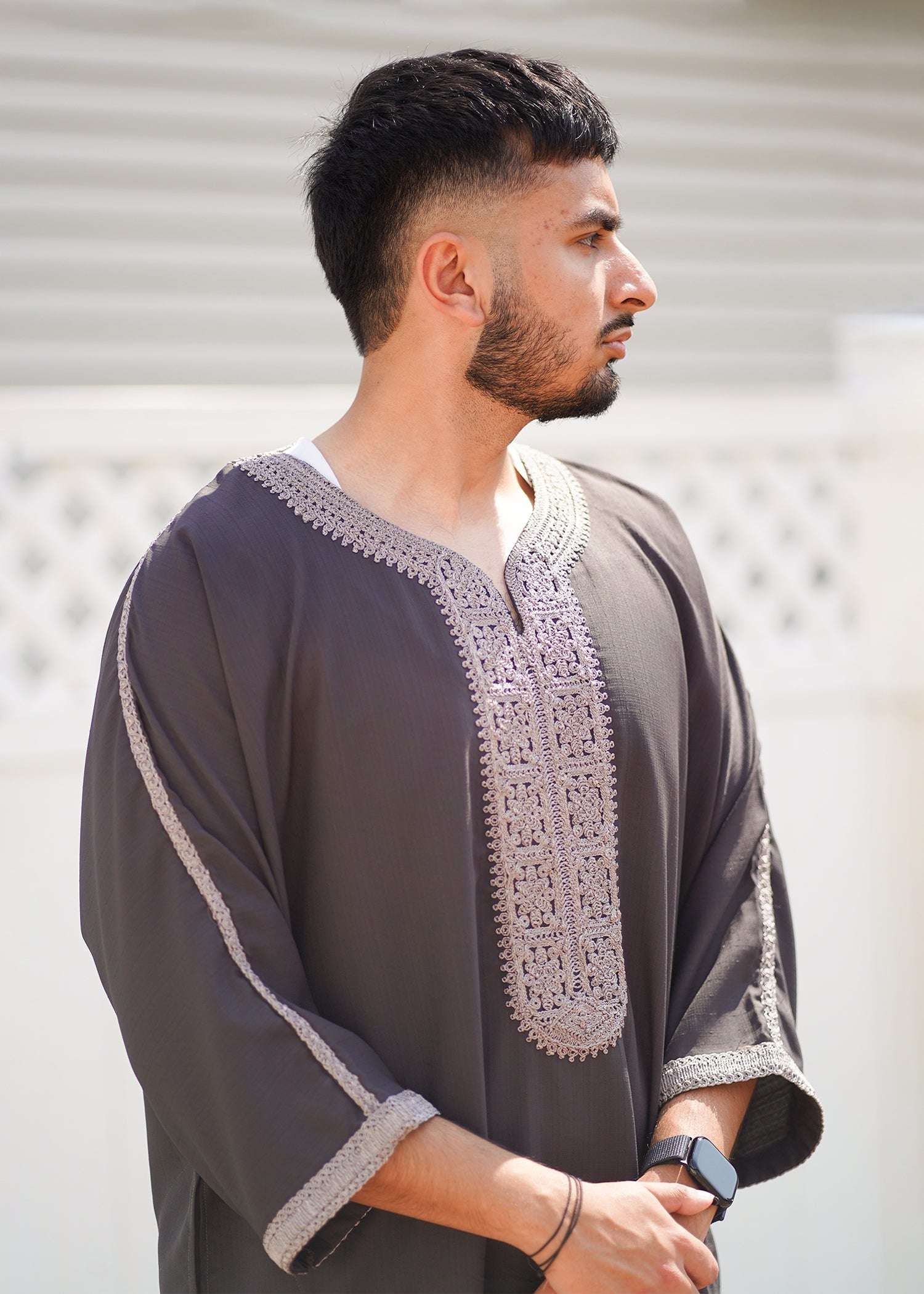 Side view of the taupe gandora showing the loose sleeves and comfortable drape