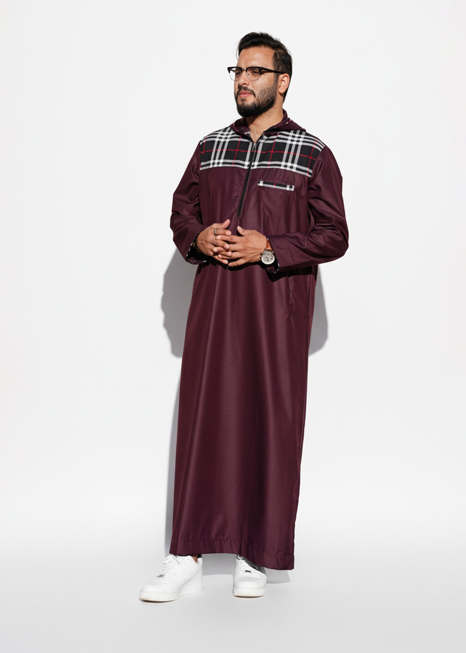 Close up of the bold plaid design on the chest and shoulders of the burgundy men's jubba