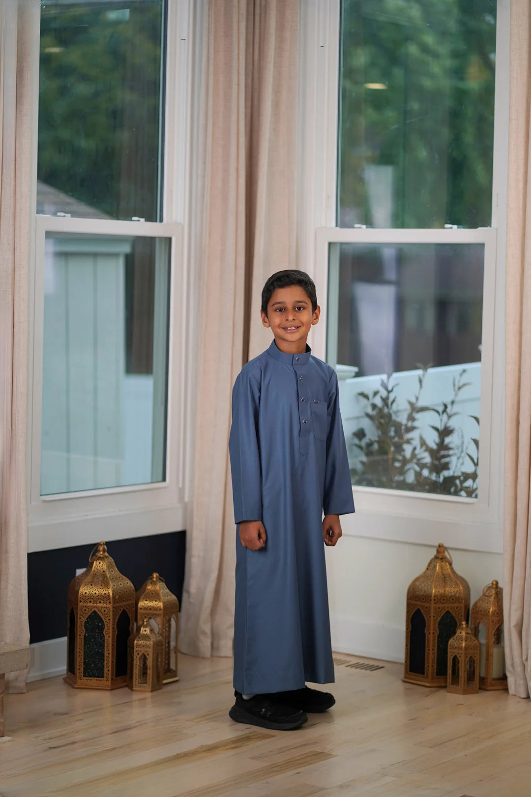 Macro shot showing the soft, breathable fabric texture of the premium dusty blue thobe.