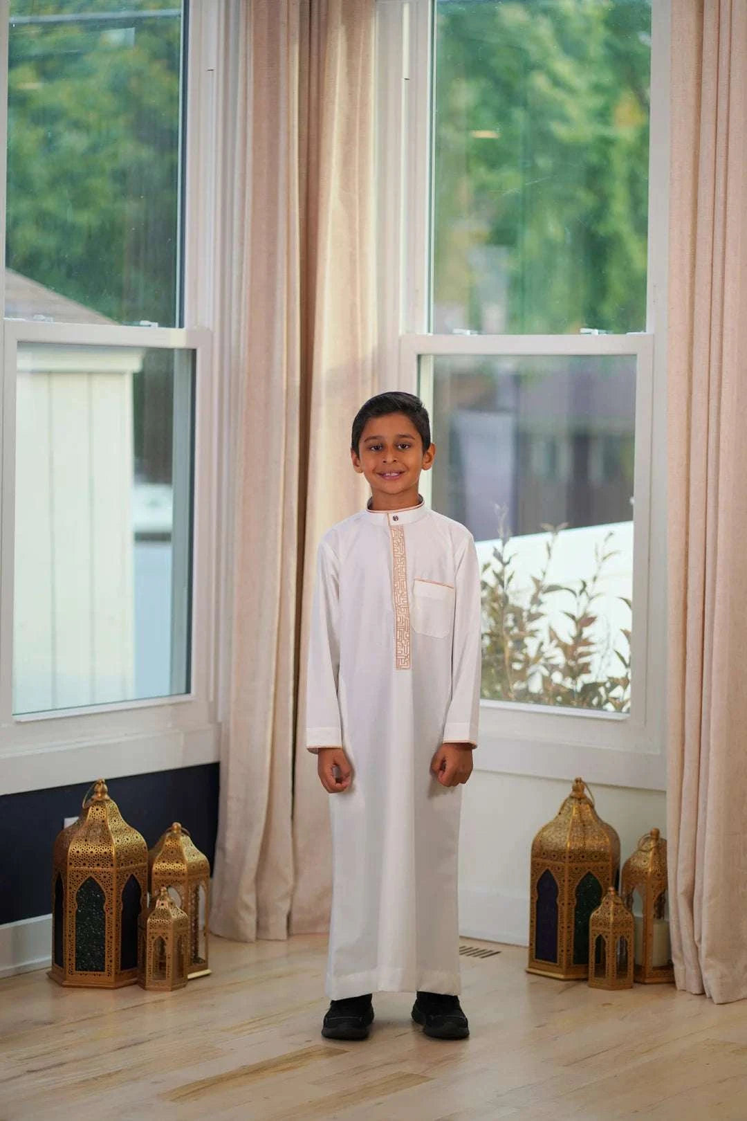 Cream and gold embroidered thobe for boys, close-up of the fabric