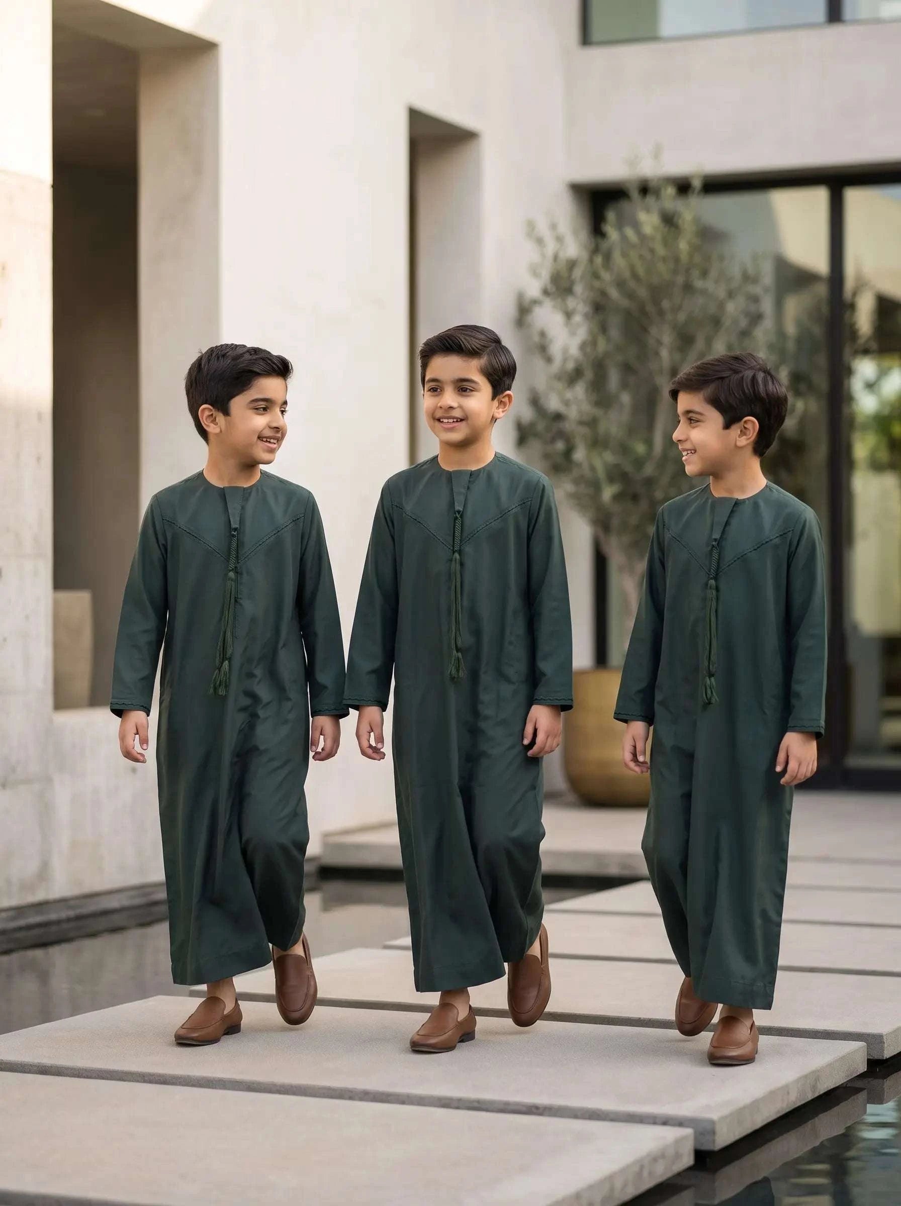 Dark green Emirati jubba for boys, shown from the front