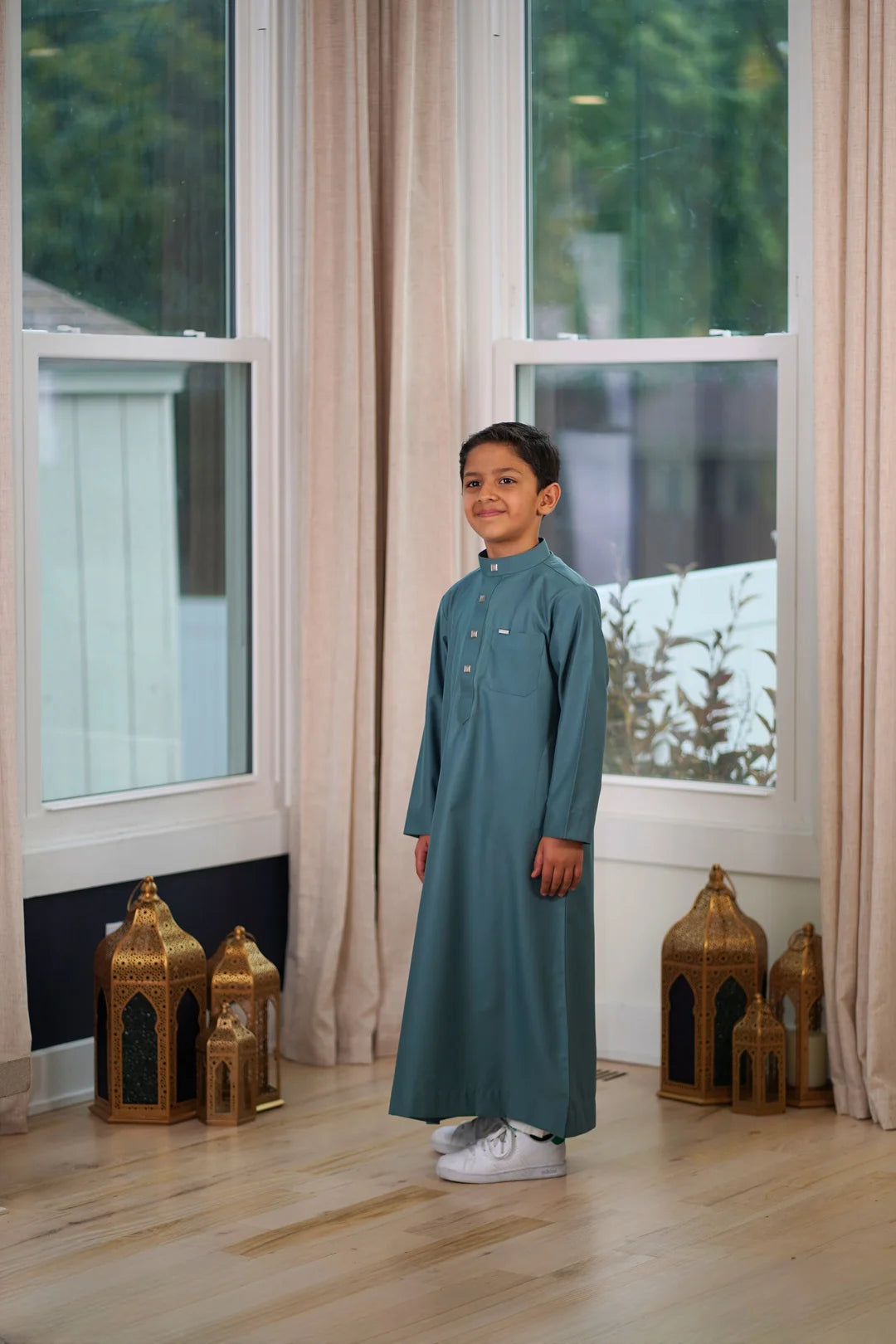 Close up of the high quality stitching on the sleeve cuffs of the slate green kids thobe