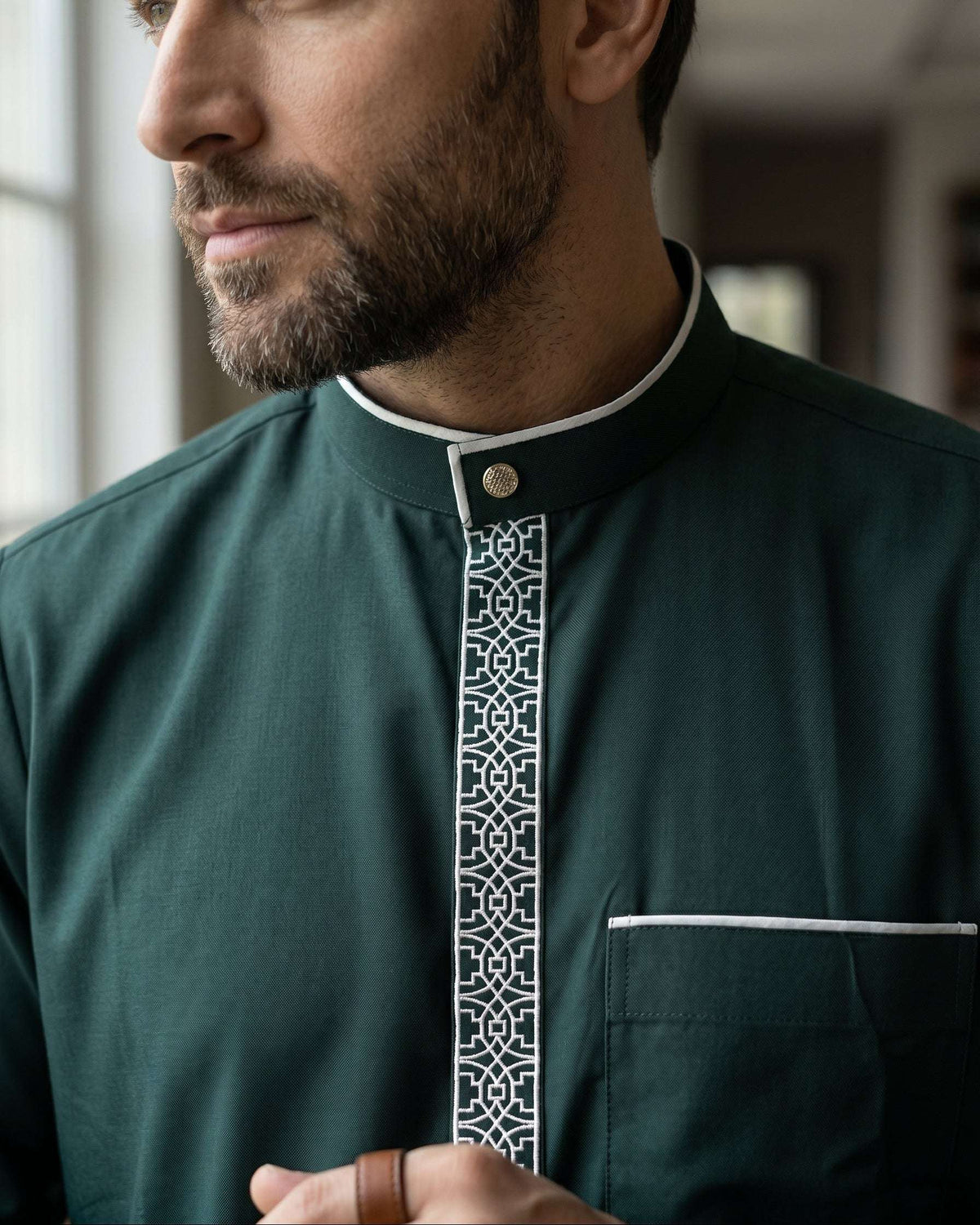 Emerald green executive thobe with geometric embroidery for men, stitched pattern in close detail