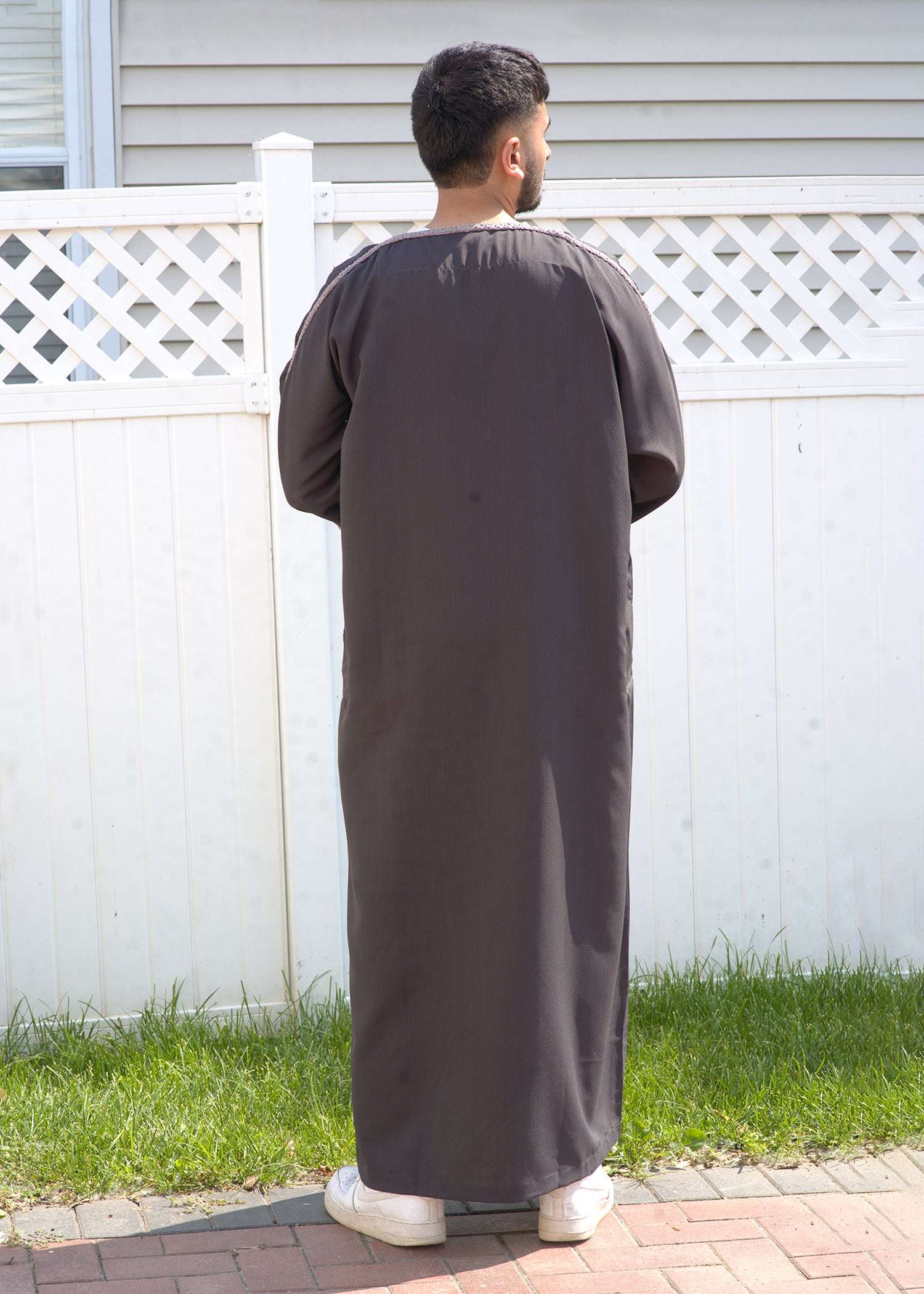 Lifestyle shot of a man wearing the taupe and silver gandora, looking confident and stylish