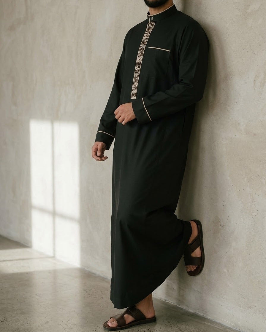Men's Black & Gold Embroidered Thobe – Mandarin Collar, three-quarter stand, grey studio, window shadow – The Topi Wala