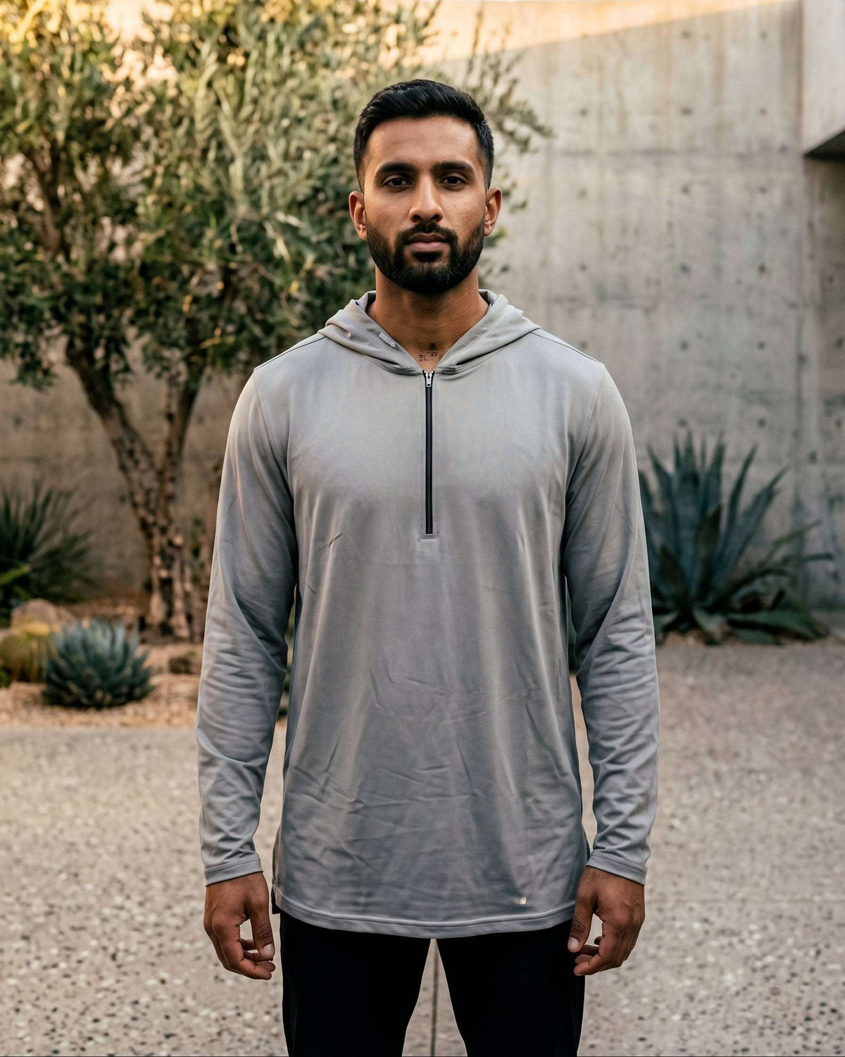 Light grey hooded kurta with half-zip jersey for men, worn by a model outdoors