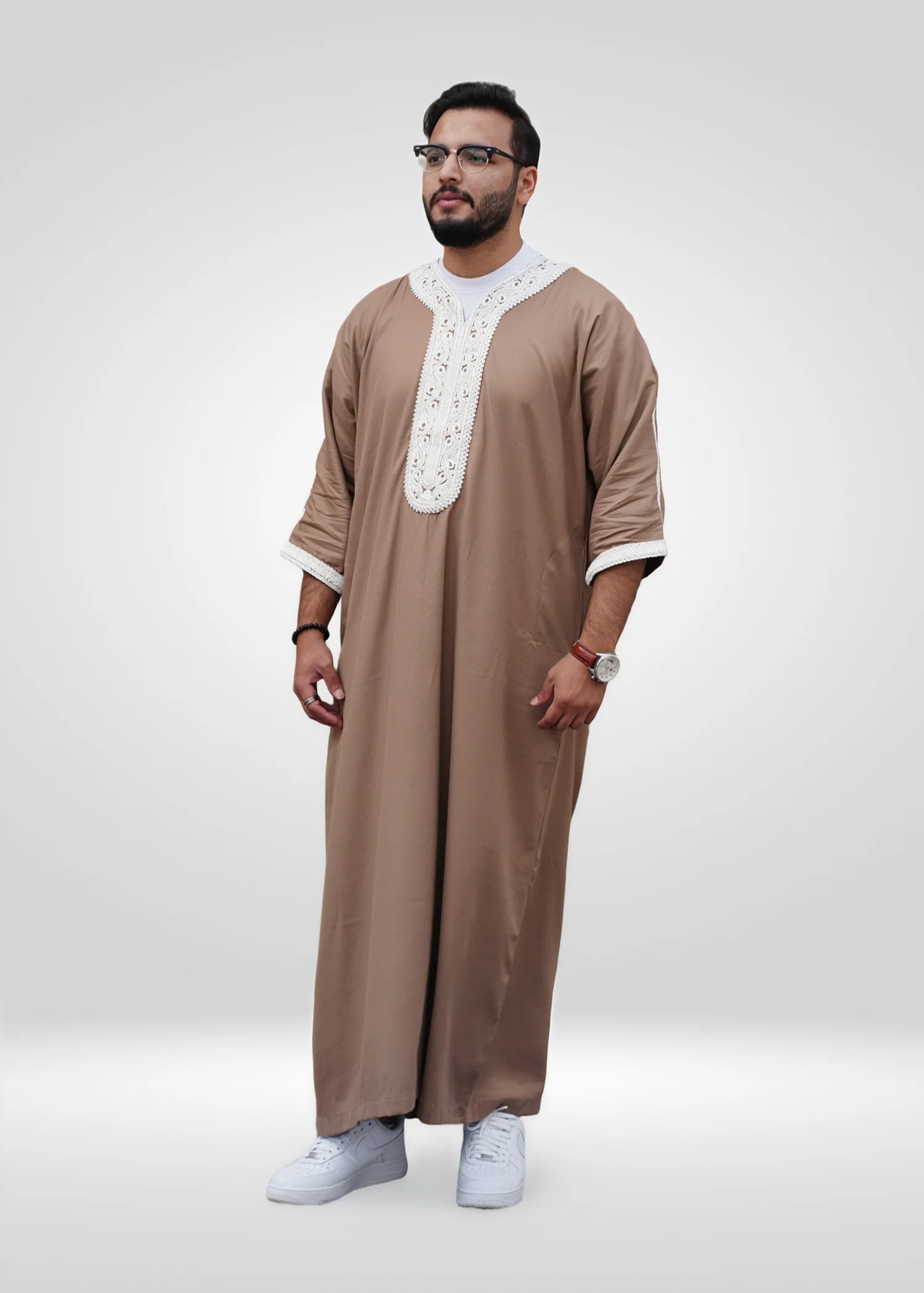 Lifestyle shot of a man wearing the beige and white gandora, looking relaxed and stylish