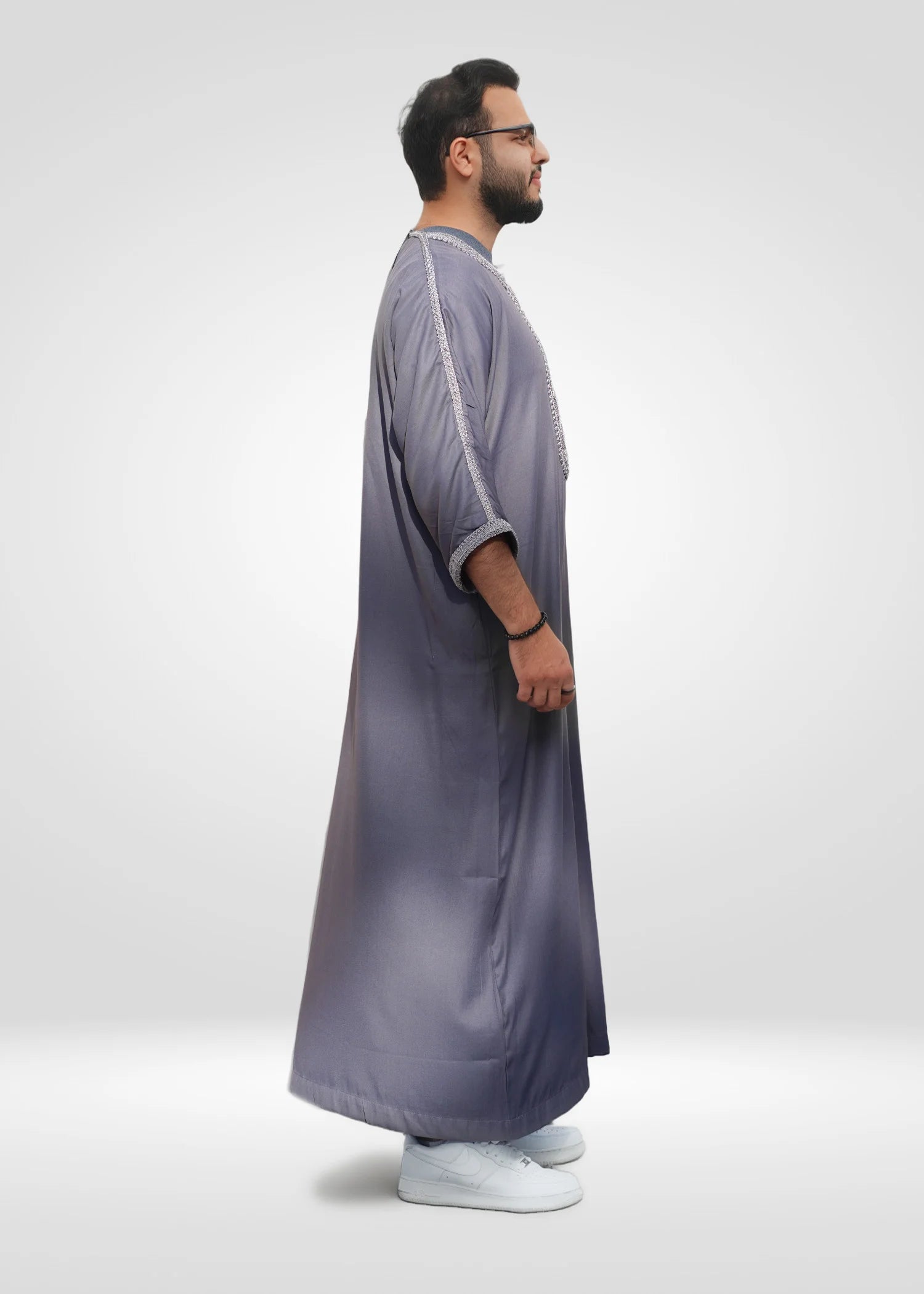 Lifestyle shot of a man wearing the mauve gray and silver gandora, looking confident and stylish