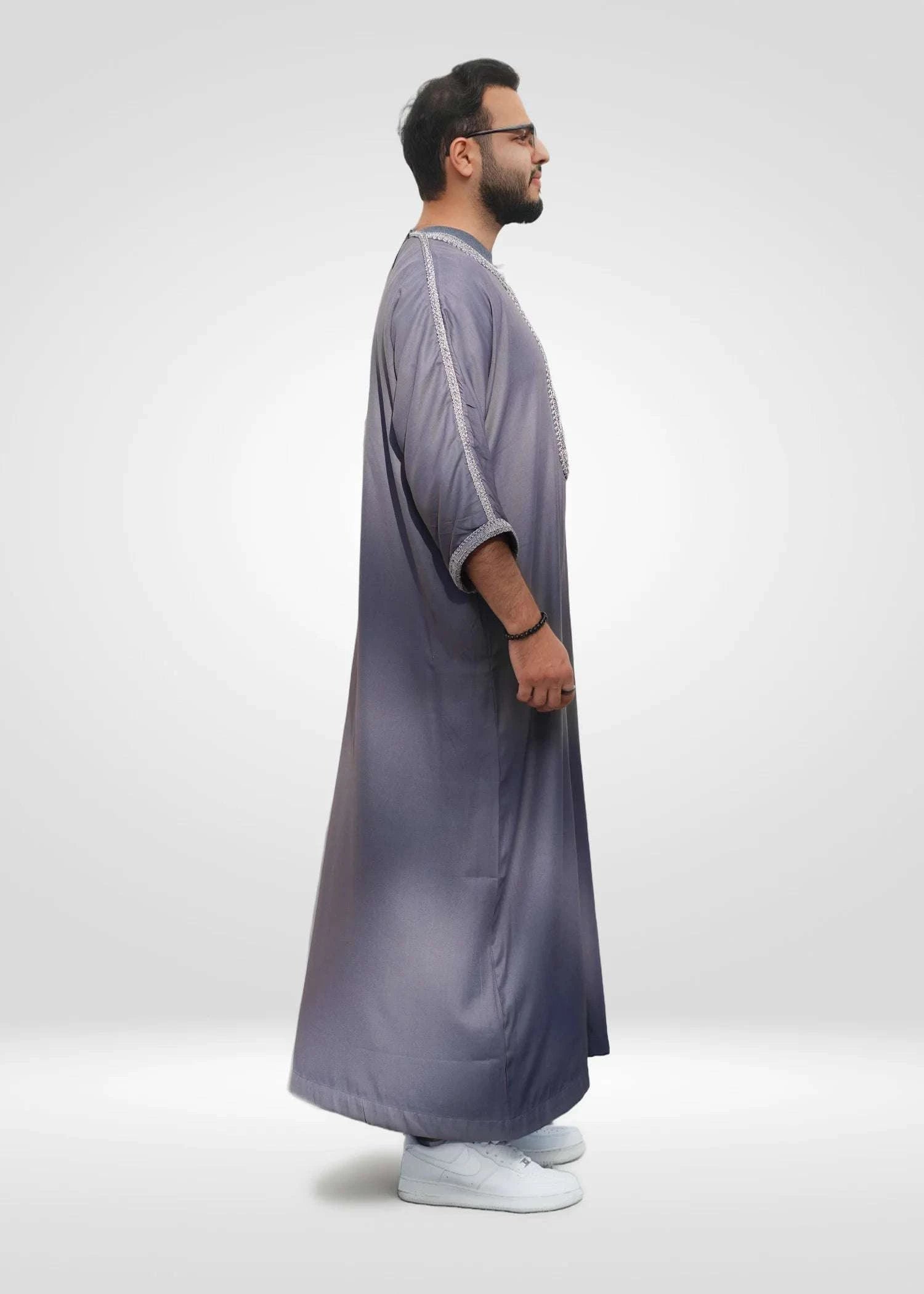 Lifestyle shot of a man wearing the mauve gray and silver gandora, looking confident and stylish