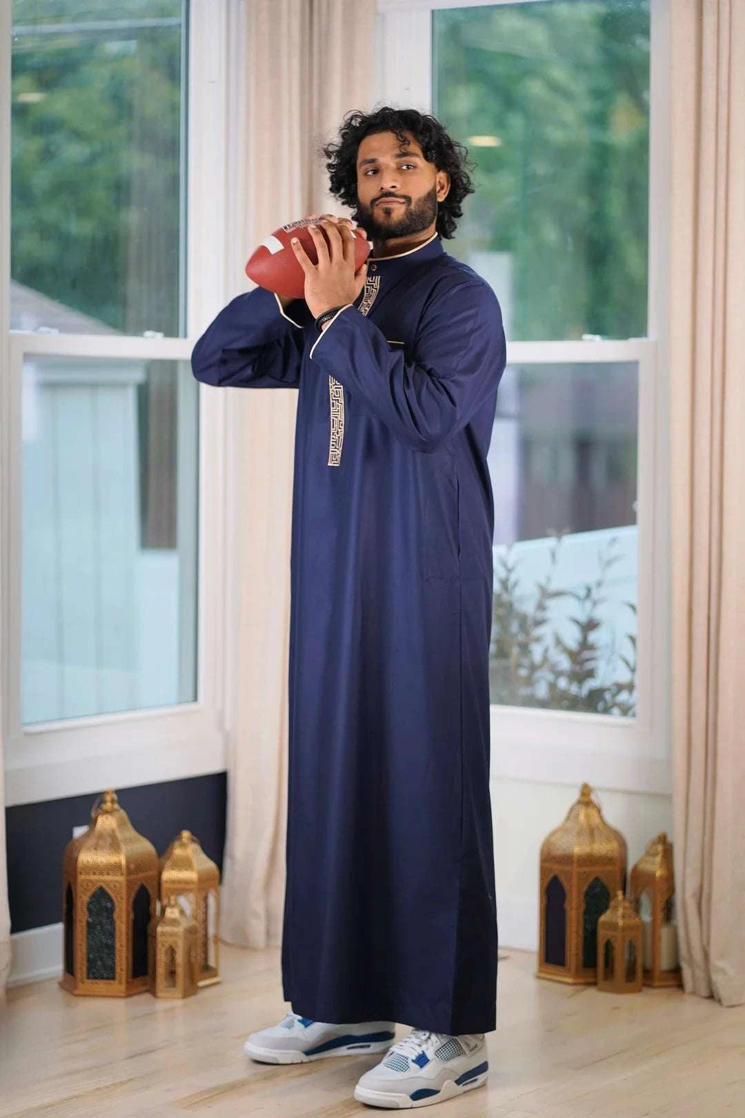 Side profile view of the men's navy thobe showing the structured formal fit