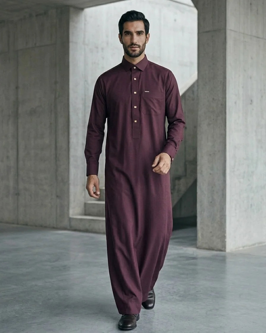 Man walking toward camera in premium maroon thobe with shirt collar and gold square engraved buttons, full length — Saudi style men's thobe by The Topiwala