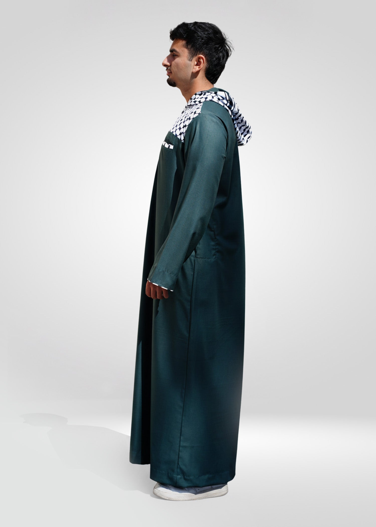 Close up of the chest pocket with matching kufiya trim on the green men's fabric