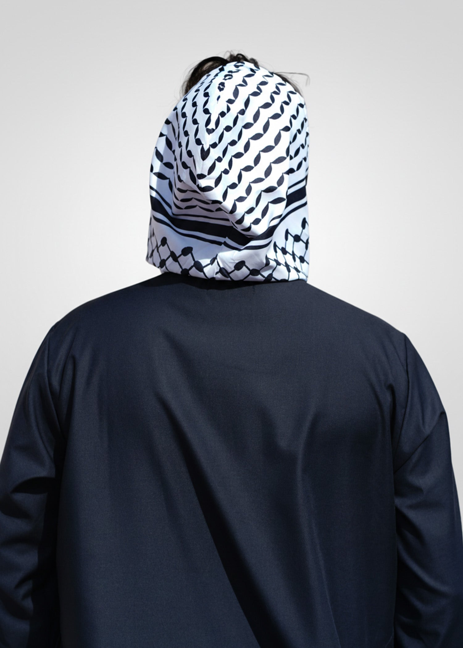 Detail shot of the front zipper and patterned hood on the black casual thobe