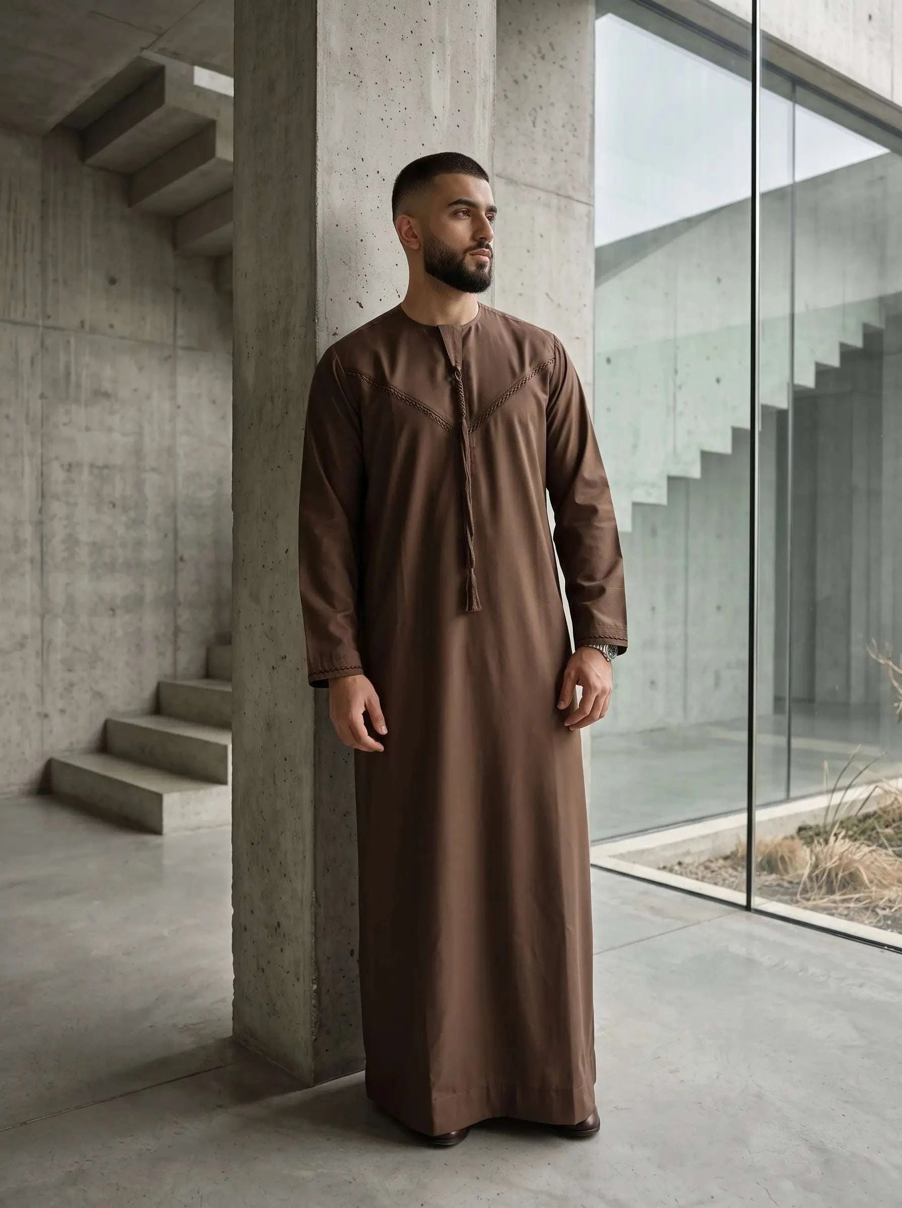 Mocha brown Emirati thobe with braided tarboush for men, close-up of the embroidered detailing