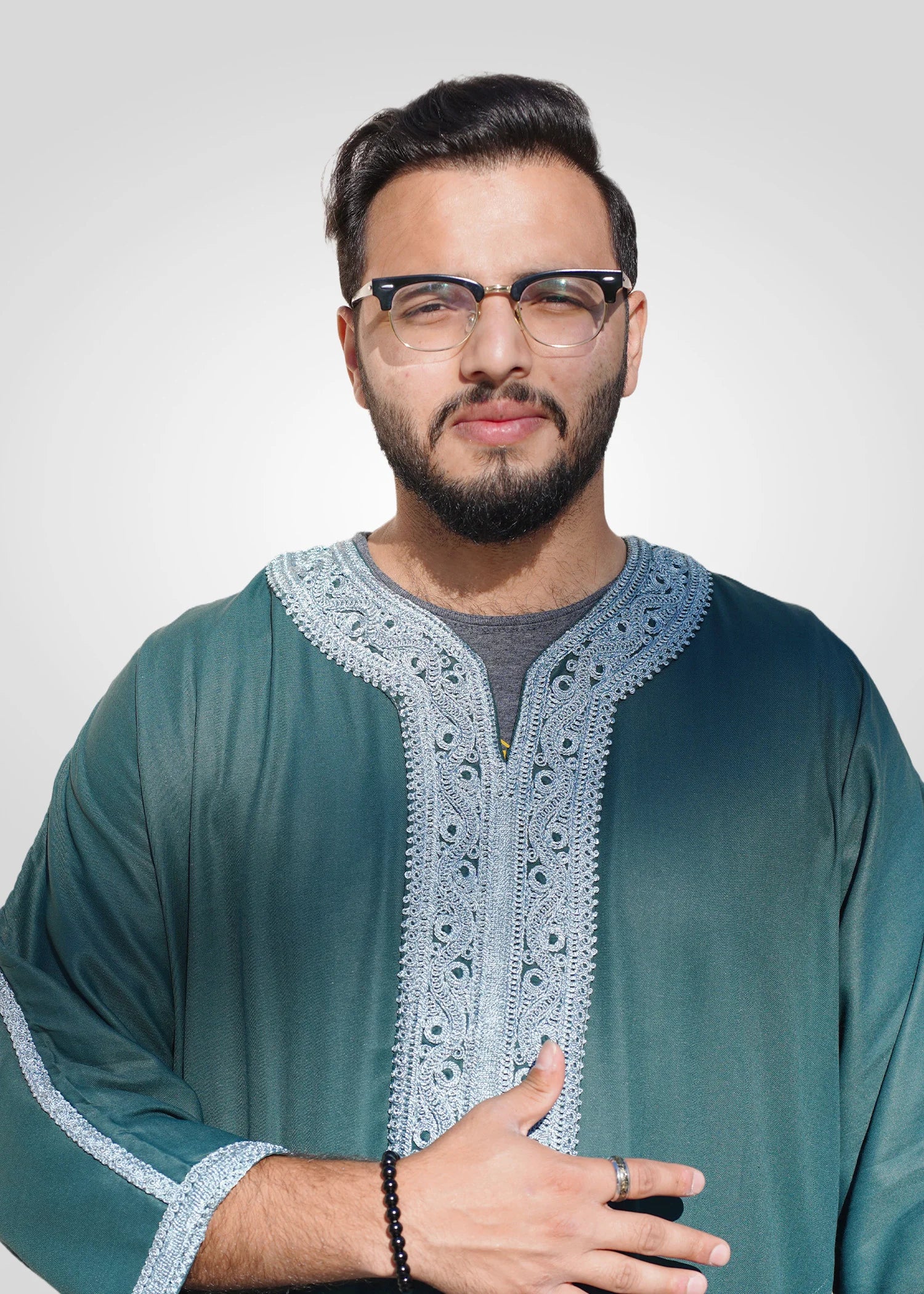 Close-up of the intricate contrast stitchwork on the placket of the formal Green Moroccan Jubba.