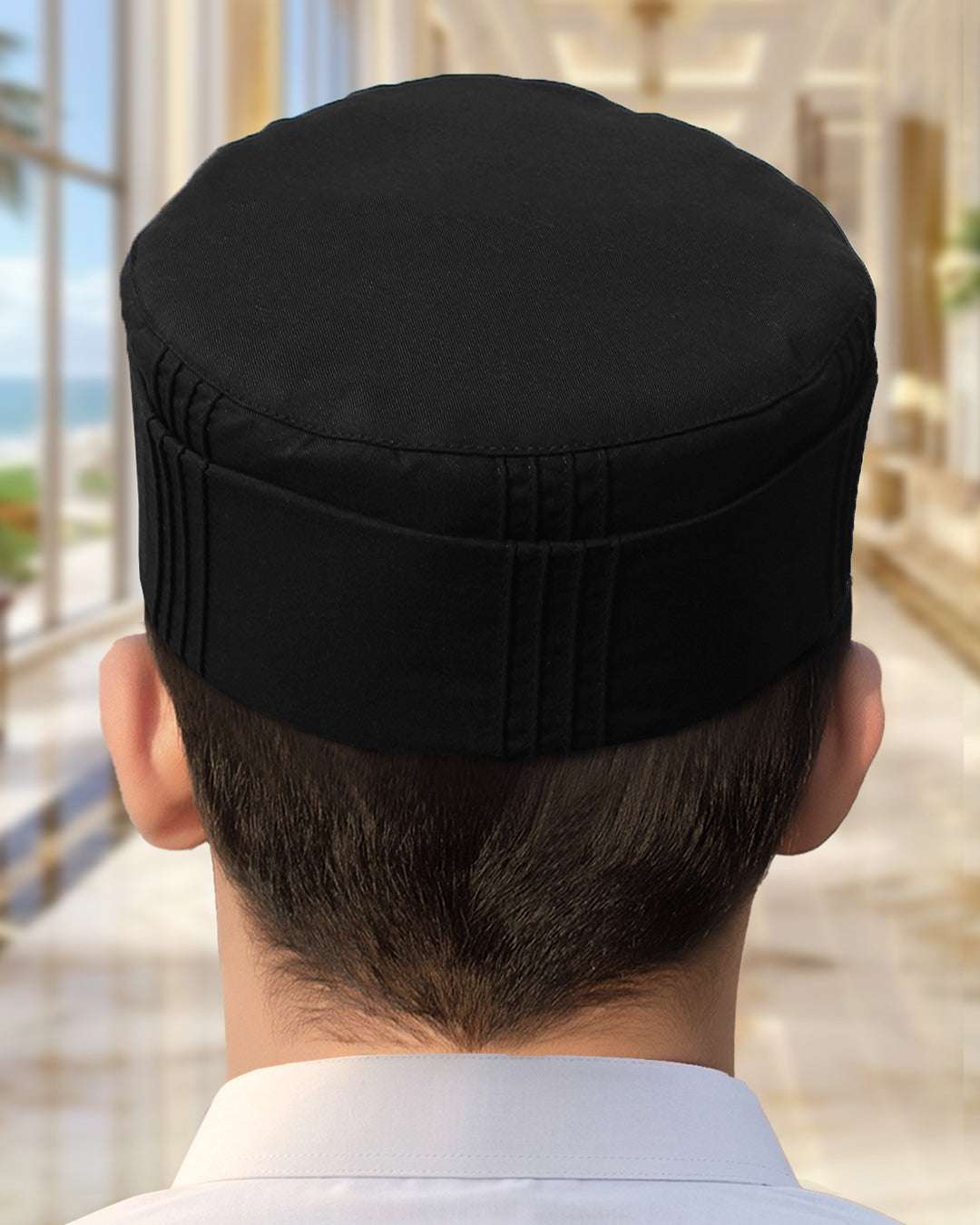 Black pleated structured kufi prayer cap for men, shown from the side