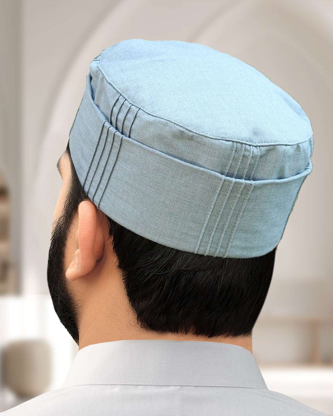 Light grey pleated structured kufi prayer cap for men, shown from behind