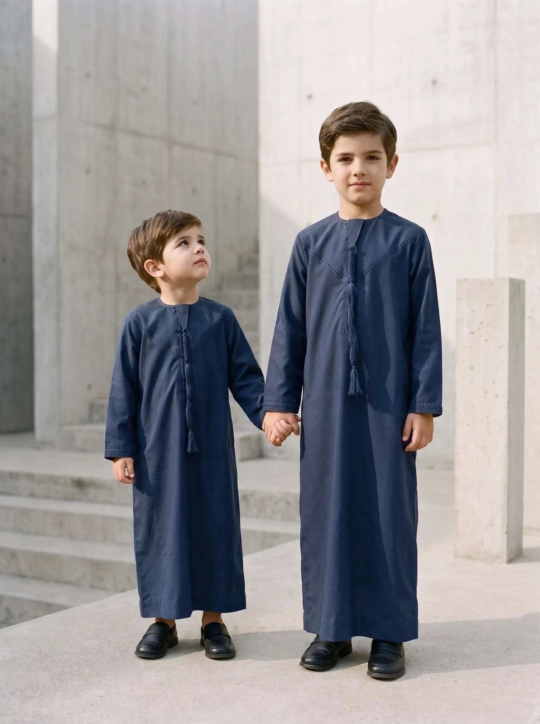 Navy blue Emirati thobe with braided tarboush for boys, close-up of the fabric