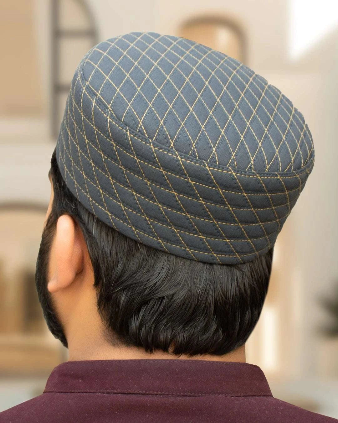 Storm gray quilted kufi prayer cap with silver stitching, stitched surface in close detail