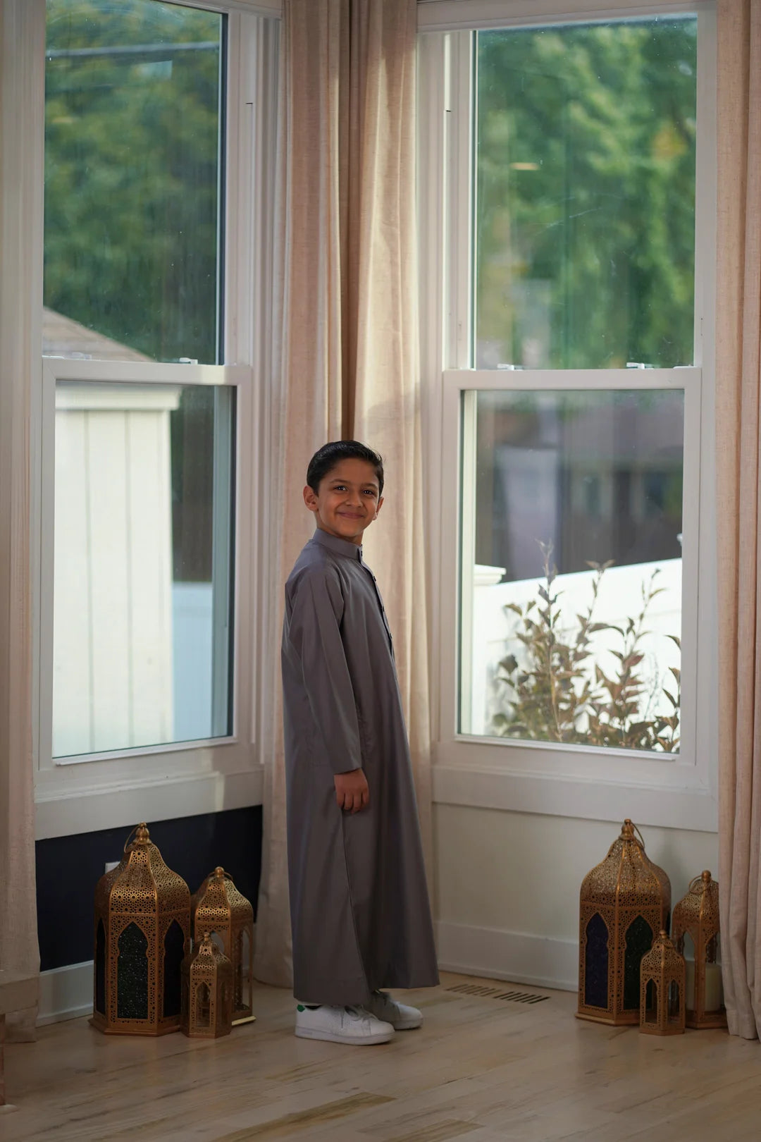 Flat lay image of the folded Plain Dark Gray Kids Thobe showcasing the deep rich color