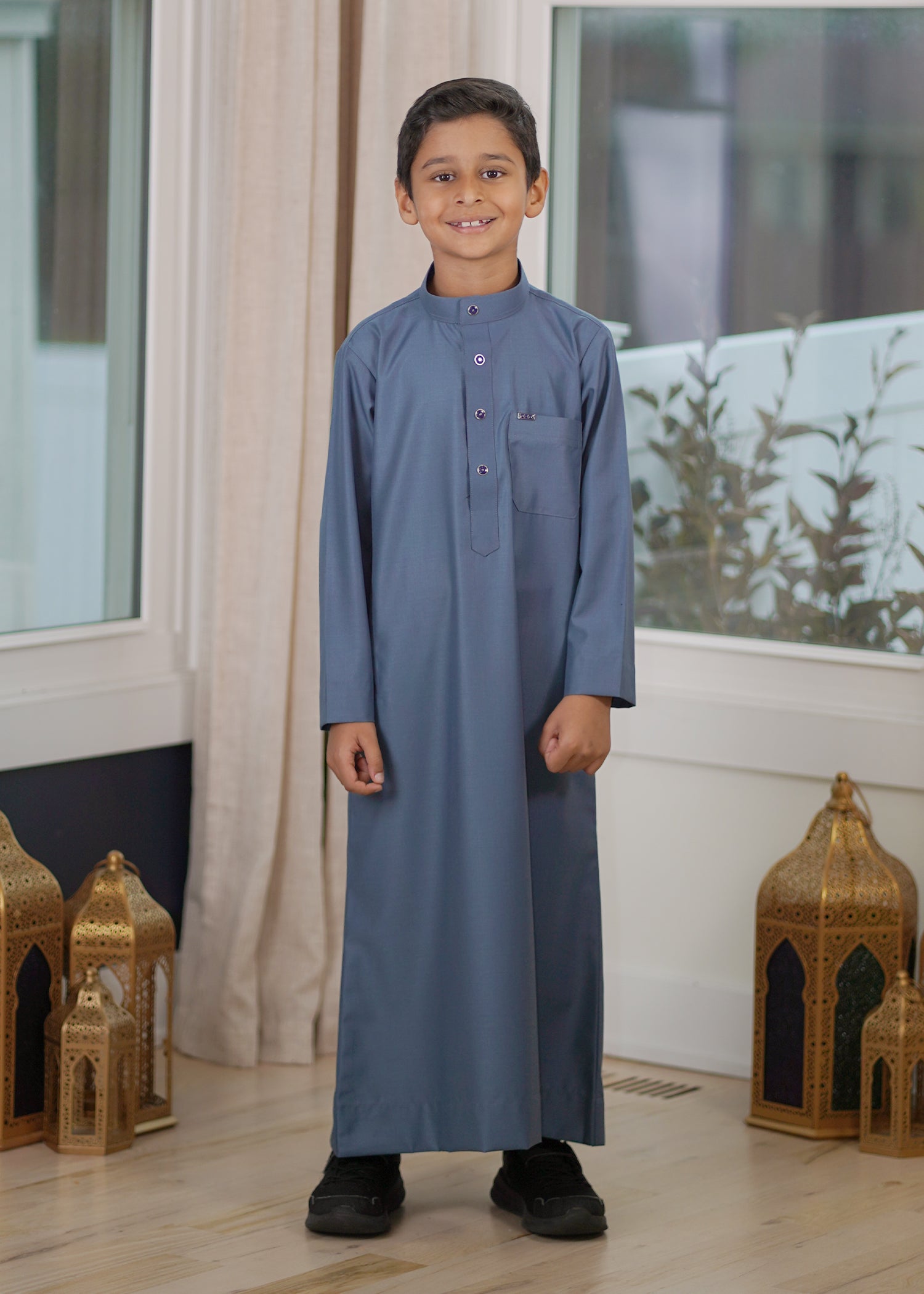 Front view of the Plain Dusty Blue Kids Thobe showing the relaxed fit and soft fabric drape