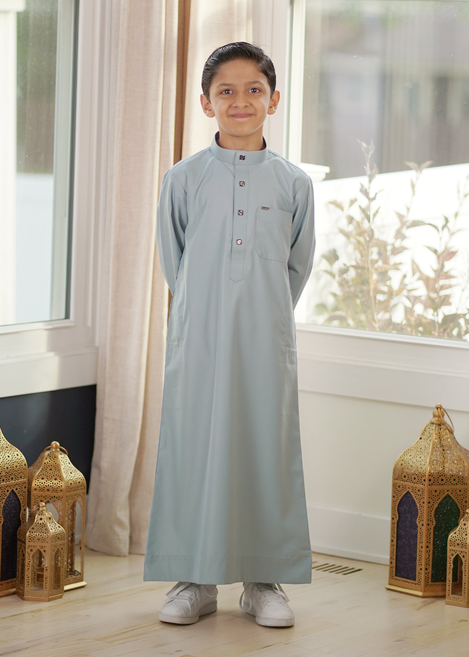 Front view of the Plain Ice Blue Kids Thobe showing the unique cool color and relaxed fit