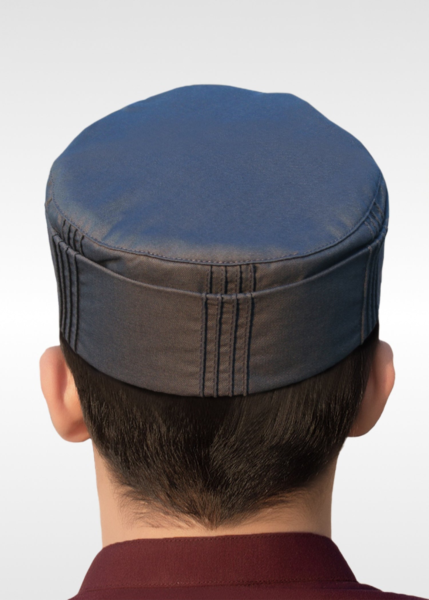 Close up of the fabric folds and pleats on the side walls of the prayer cap