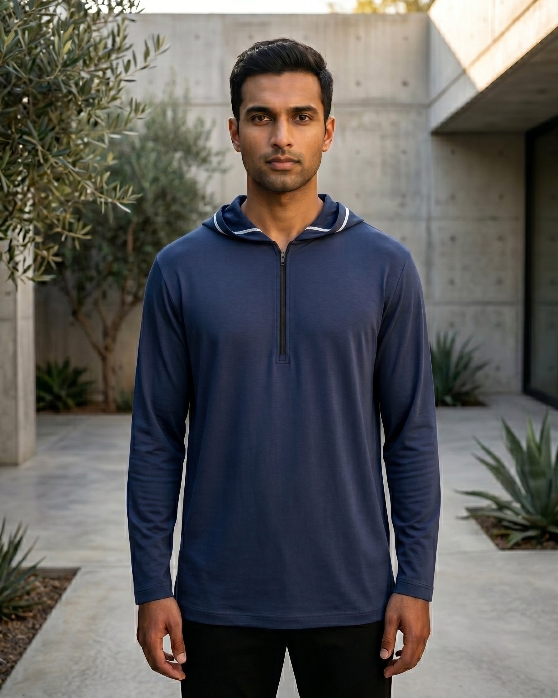 Premium navy blue jersey hooded kurta for men, half zip Islamic streetwear side profile, modest casual menswear, comfortable athleisure.