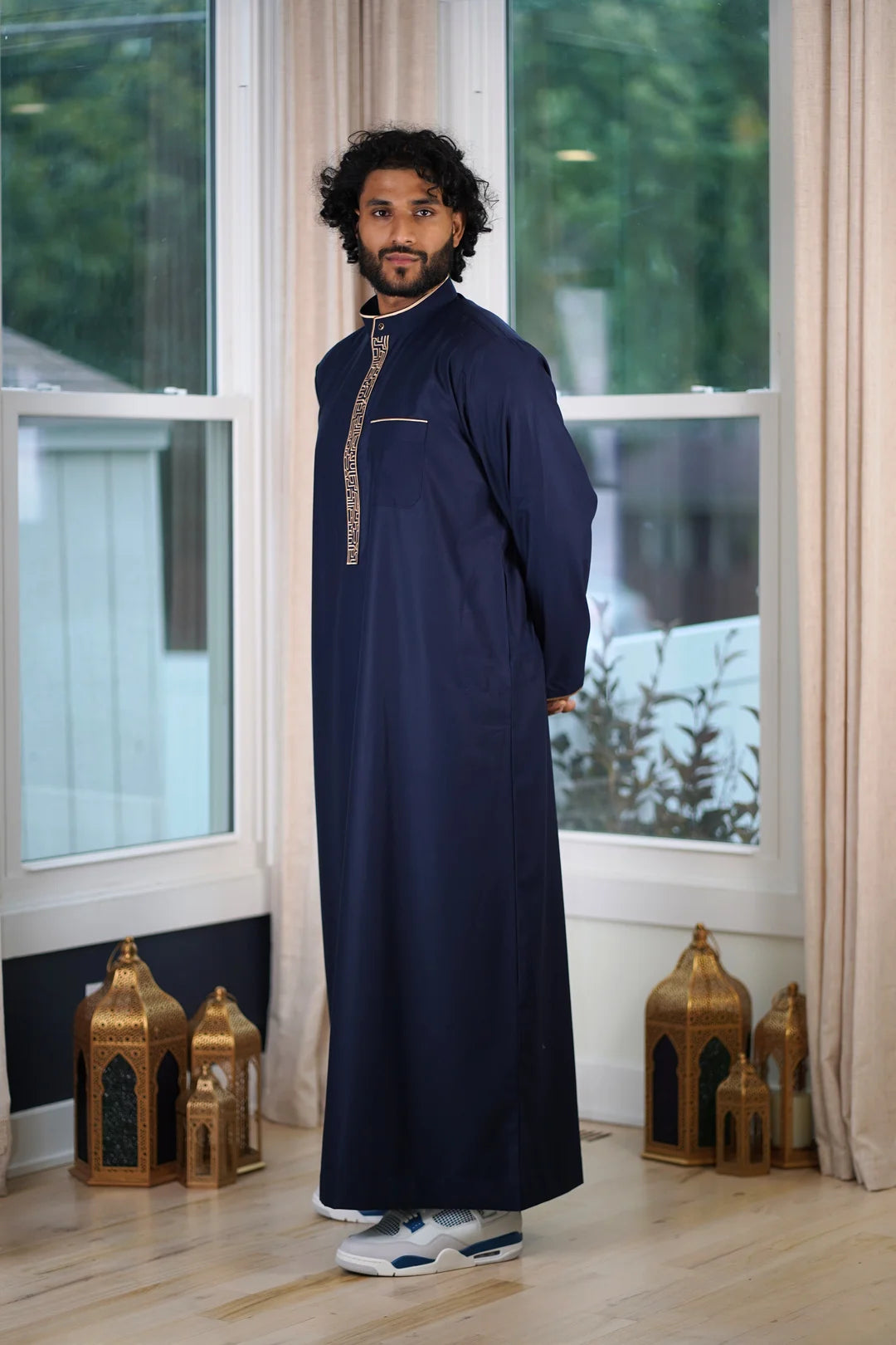 Extreme close-up of the smooth, high-end fabric texture of the navy blue Thobe material.