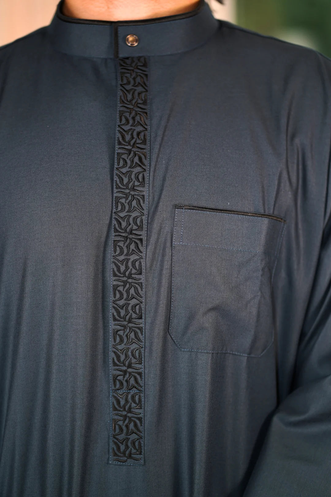 Close-up of the exclusive geometric embroidery and mandarin collar neckline on the premium Jubba in New York.