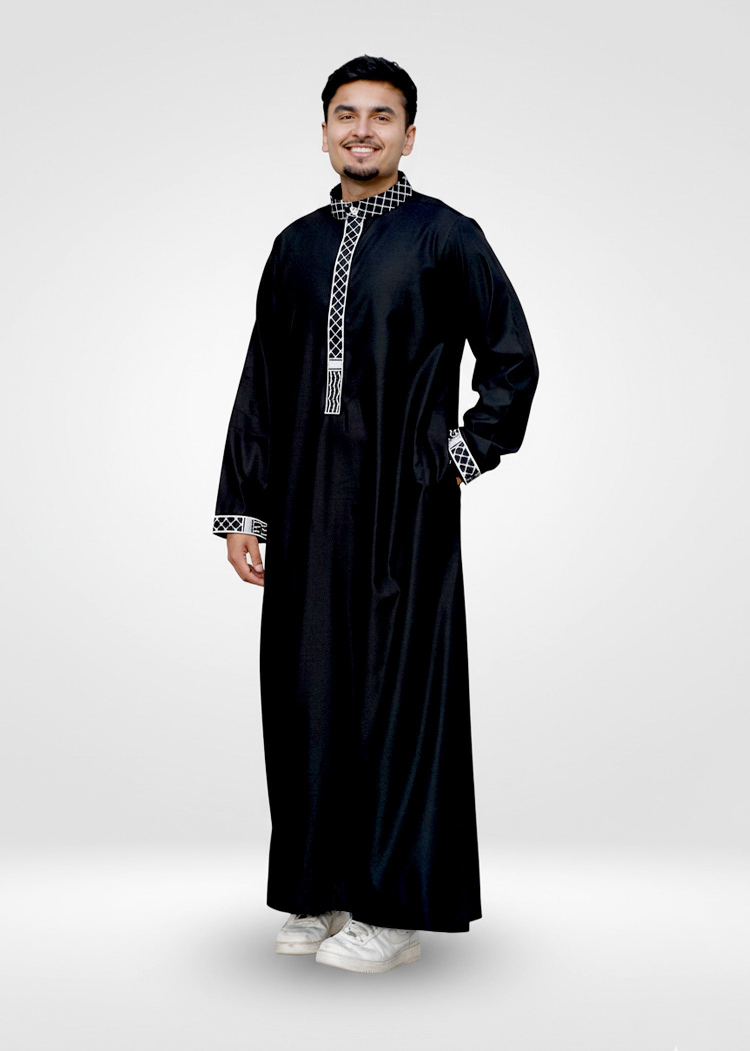 Close up of the intricate kufiya embroidery on the mandarin collar and placket of the men's jubba