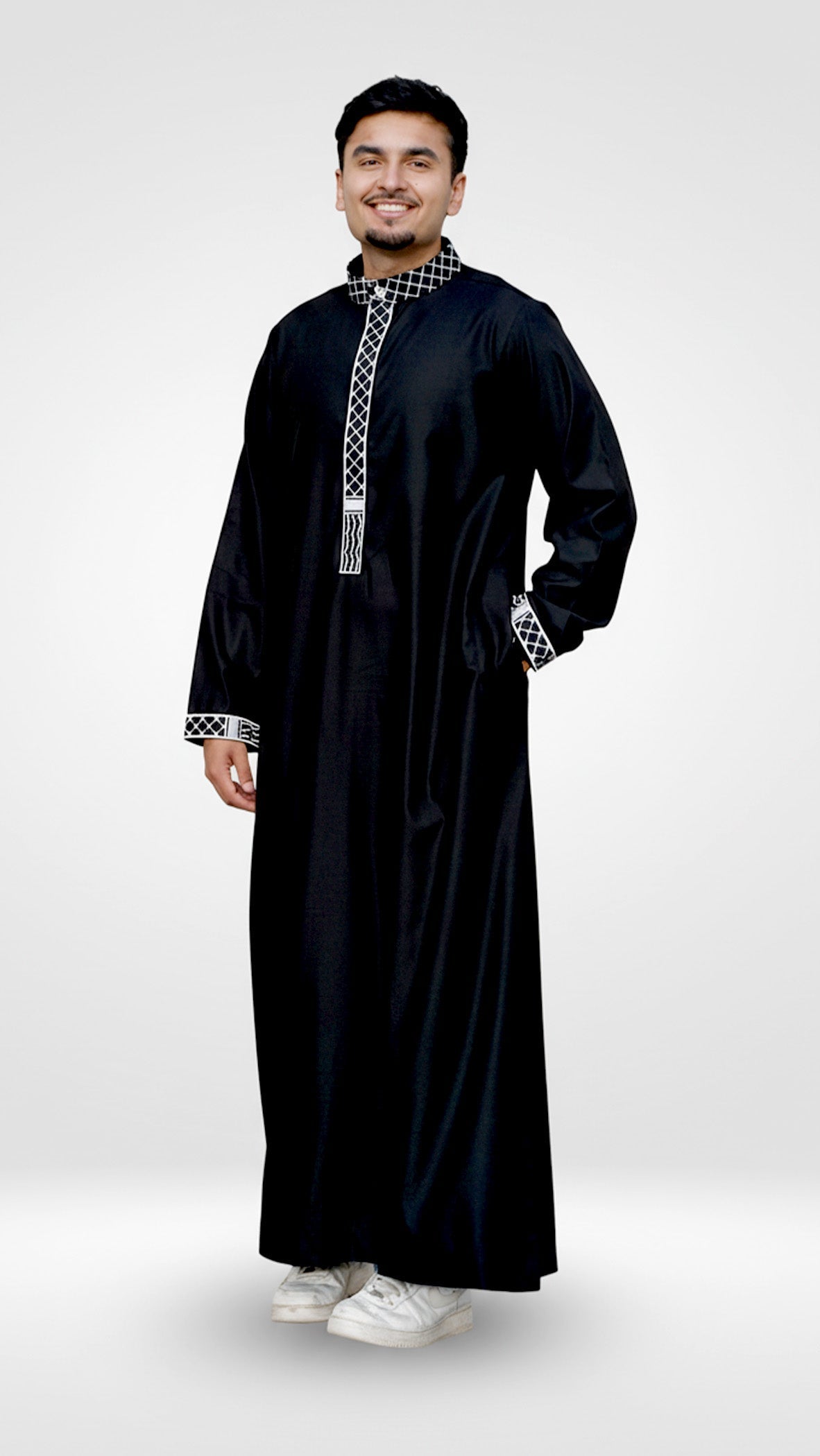 Close up of the intricate kufiya embroidery on the mandarin collar and placket of the men's jubba