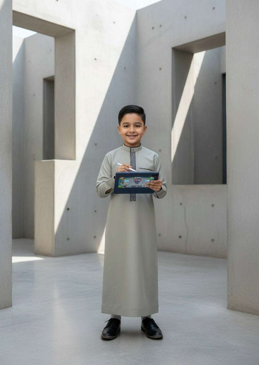 Sage green embroidered thobe for boys, styled on a model outdoors
