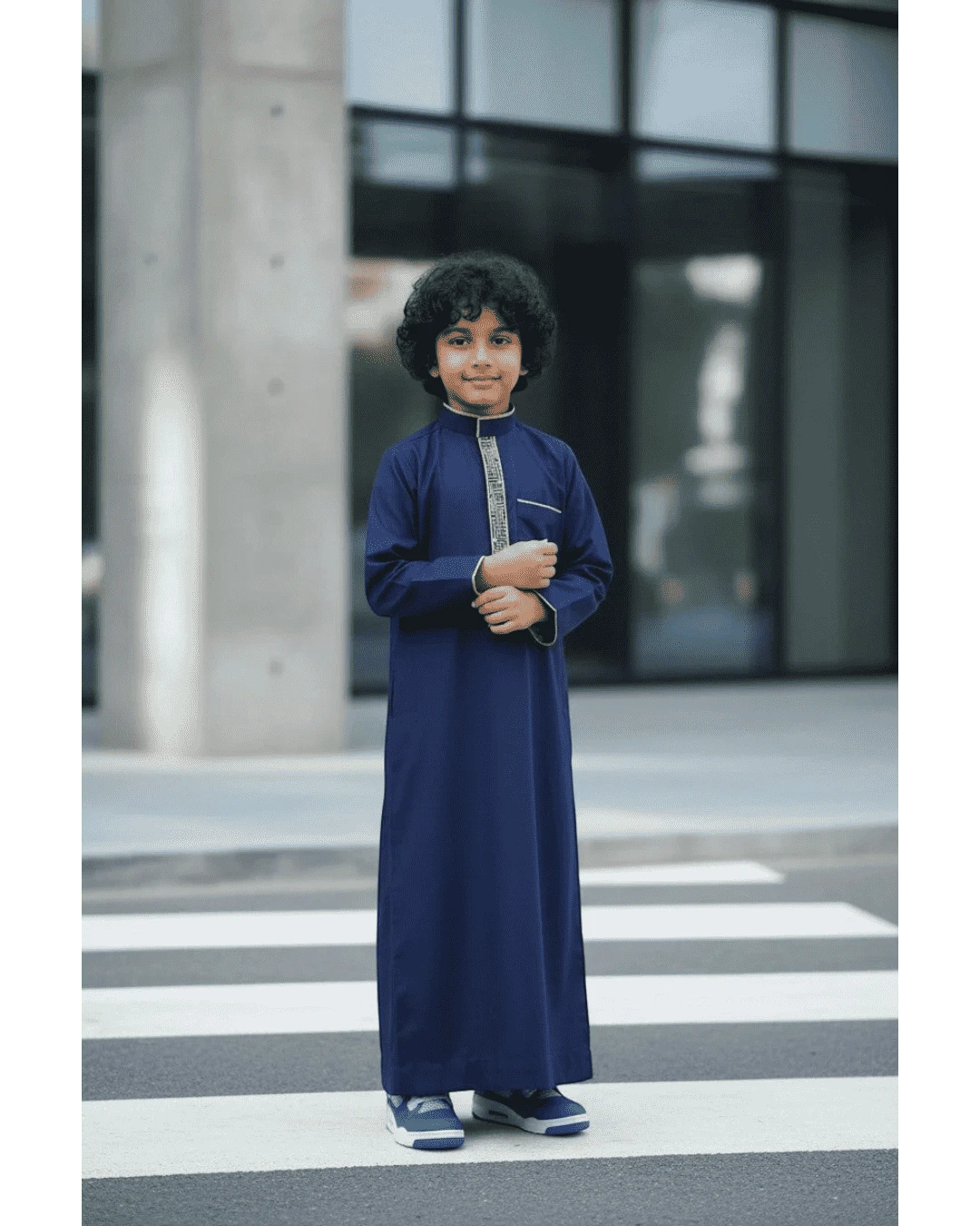 The Topi Wala navy blue boys thobe with beige and gold embroidery on the collar and cuffs. Long sleeves.